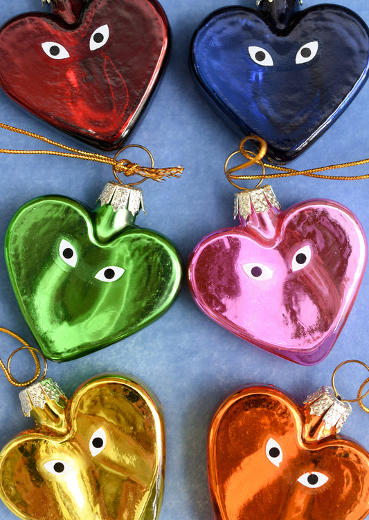 Heart shaped glass ornaments in different colors with eyeball detail.