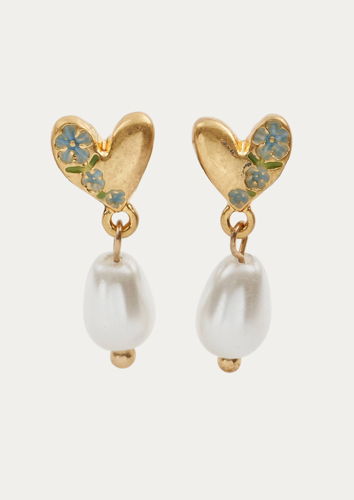 A pair of gold heart shaped earrings with a  dangling pearl.