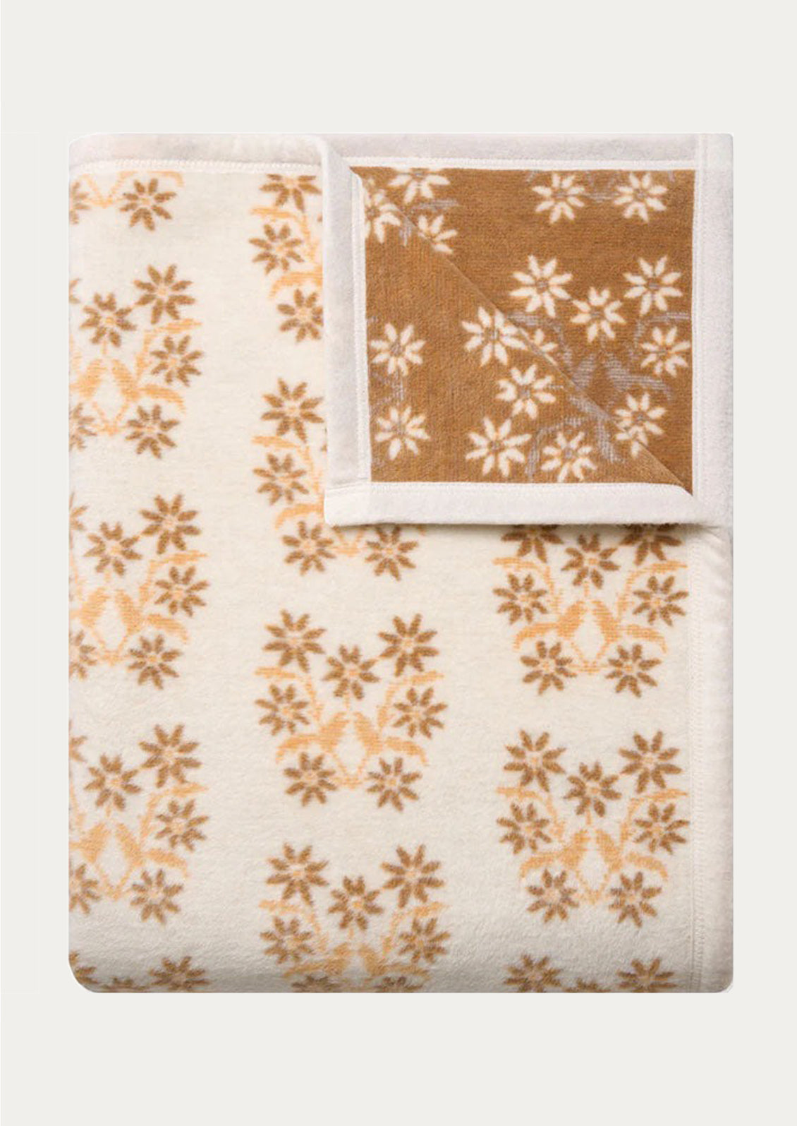 Floral-patterned blanket in brown and beige on a white background
