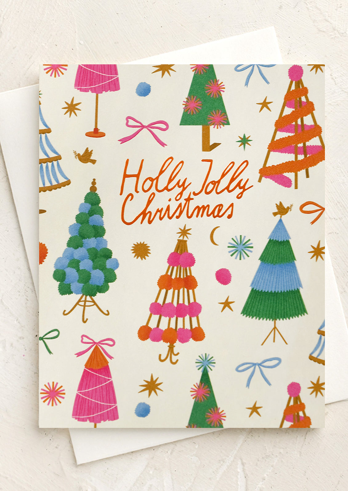 A colorful tree print card set reading "Holly jolly christmas".