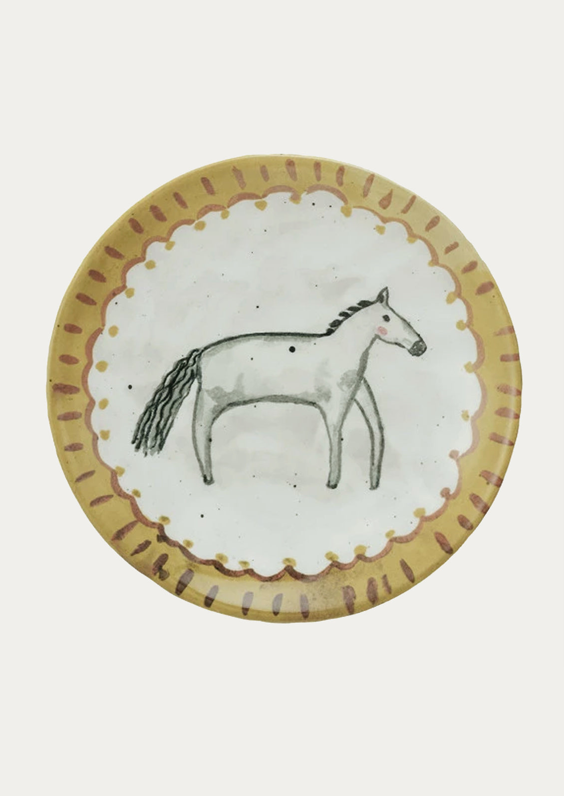 A small ceramic plate with hand painted imagery of horse.