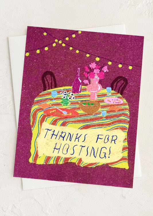 Greeting card with a colorful illustration of a table setting and 'Thanks for Hosting!' text on a purple background.