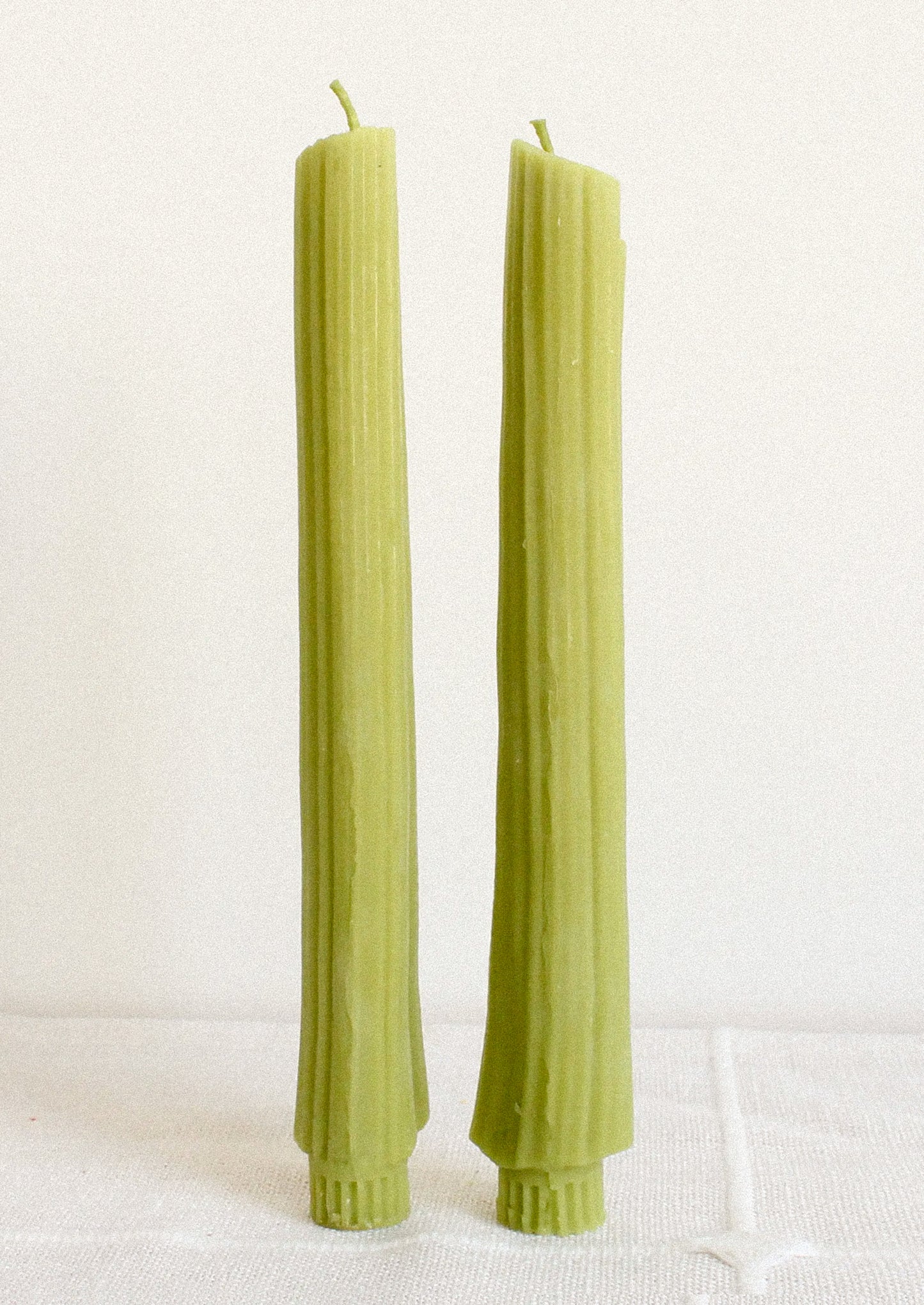 A pair of taper candles realistically shaped like celery