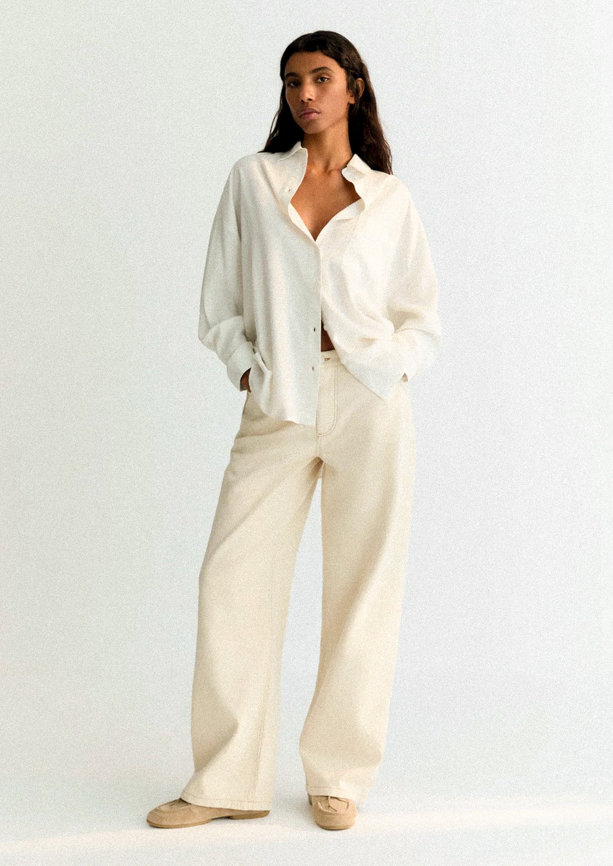 A person wearing a white button front shirt.