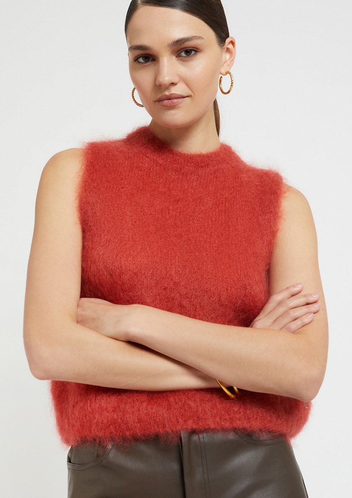 A super fuzzy sweater vest in vibrant raspberry color.
