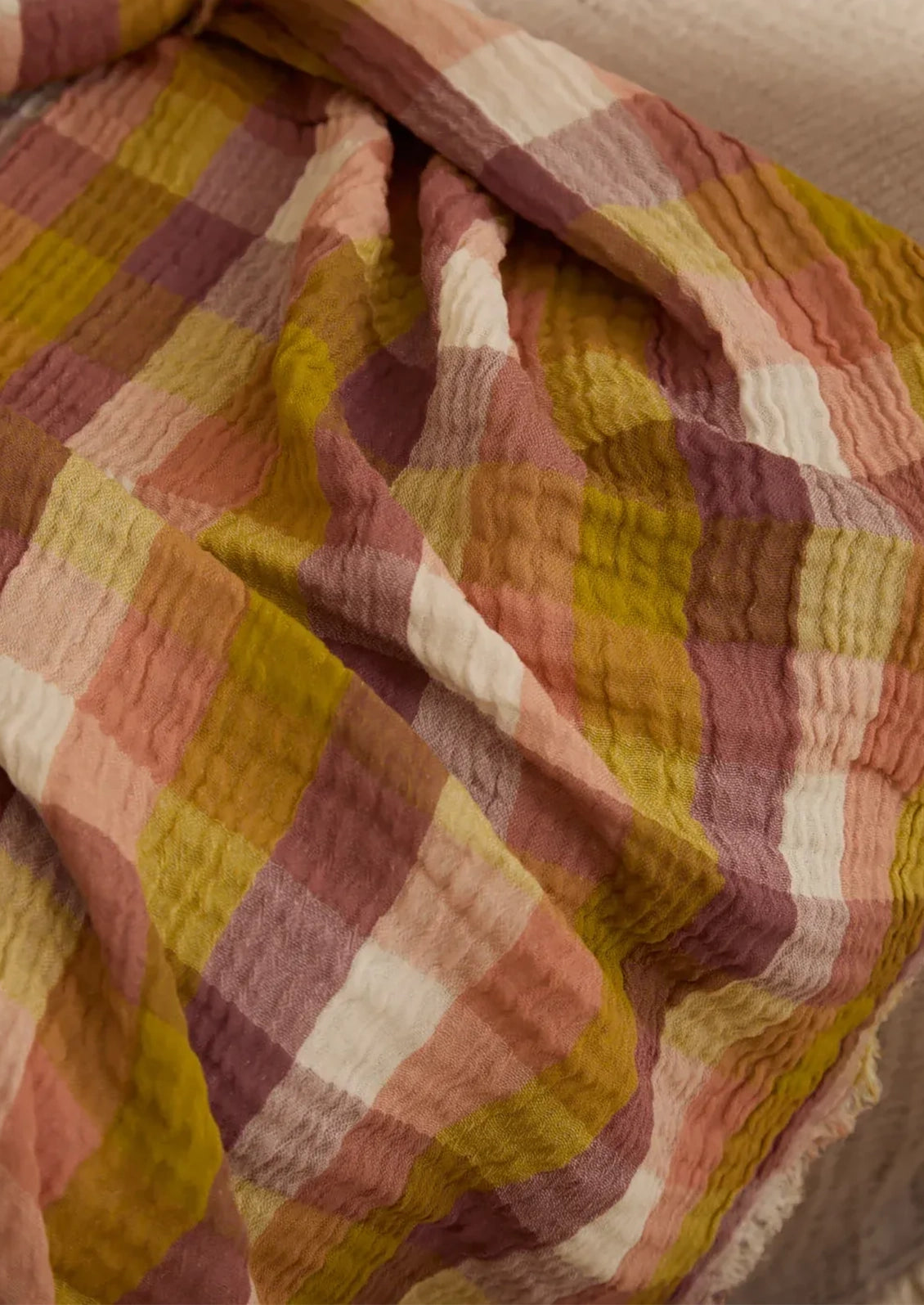 Close-up of checkered fabric with warm colors on a soft background