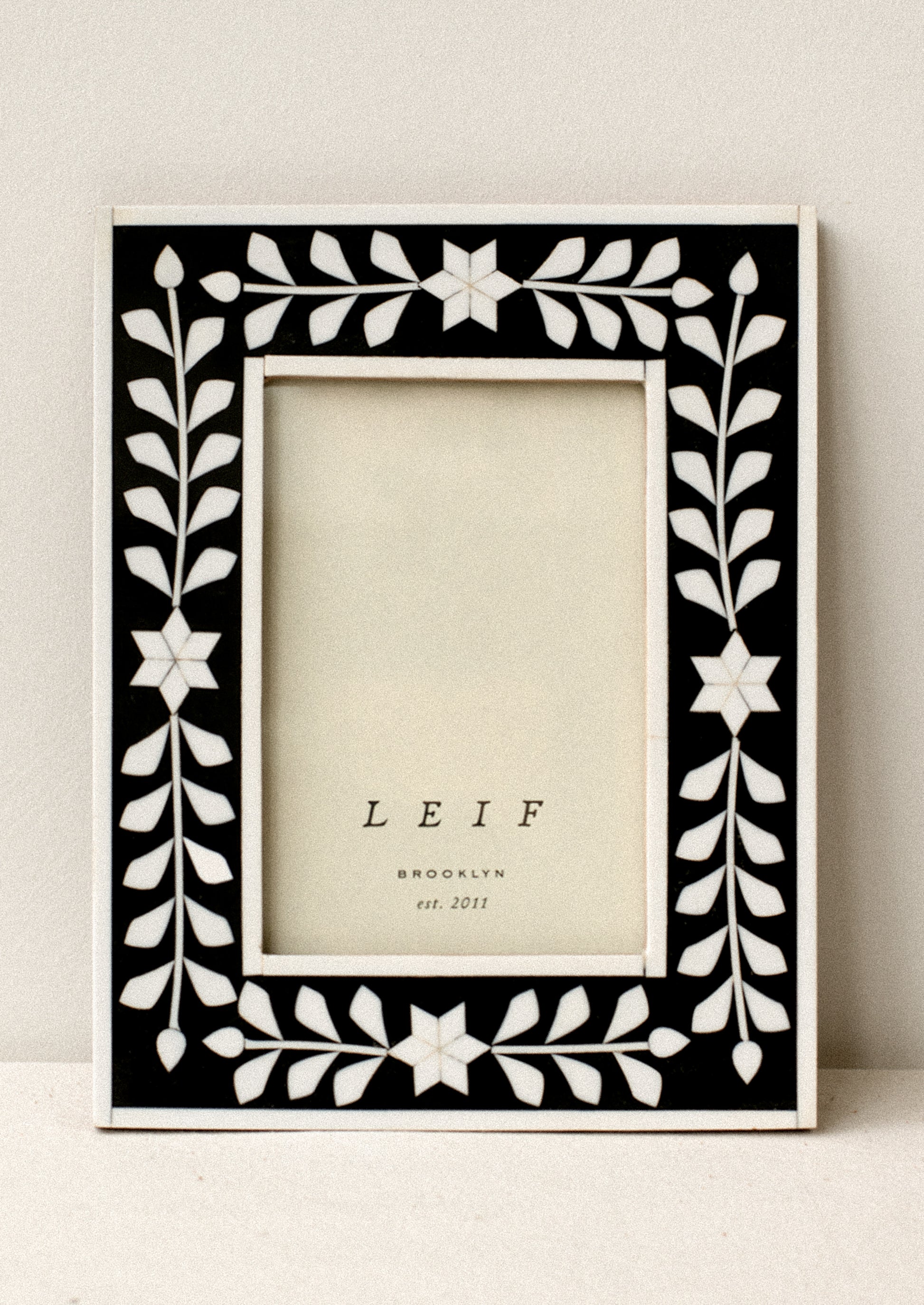A black and white inlay frame with star pattern.
