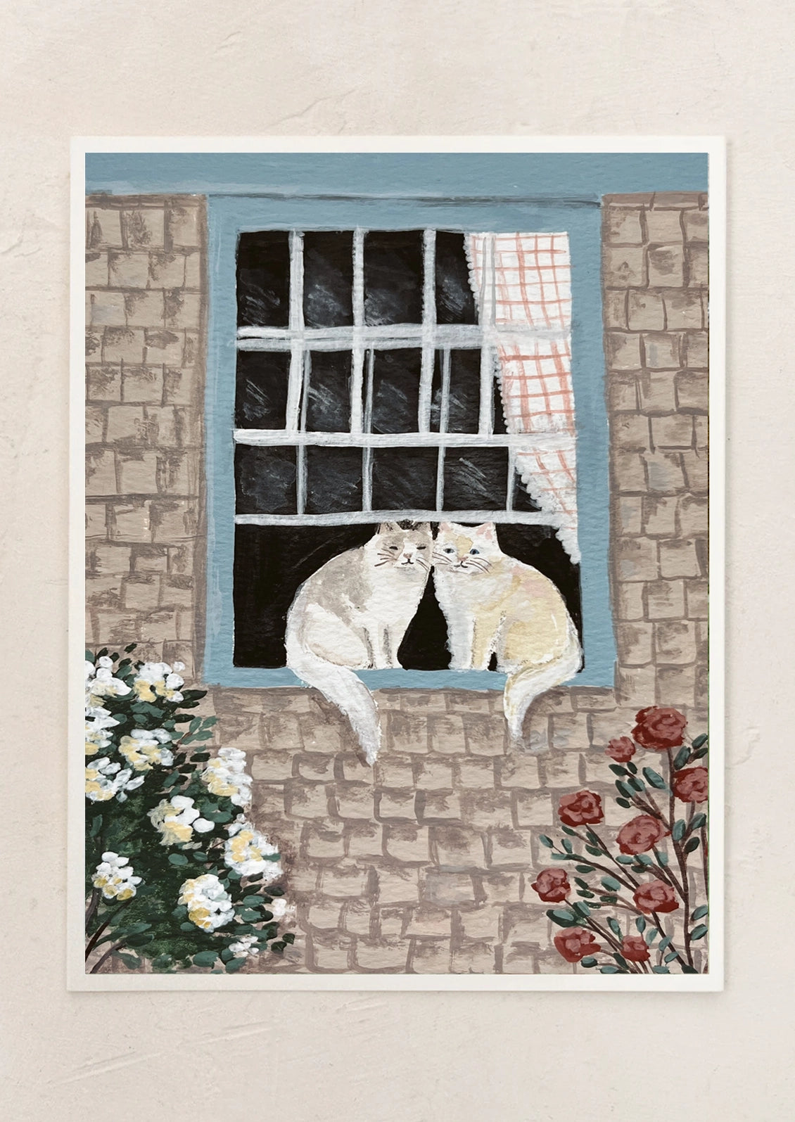 Two cats looking out a window with flowers on a stone wall