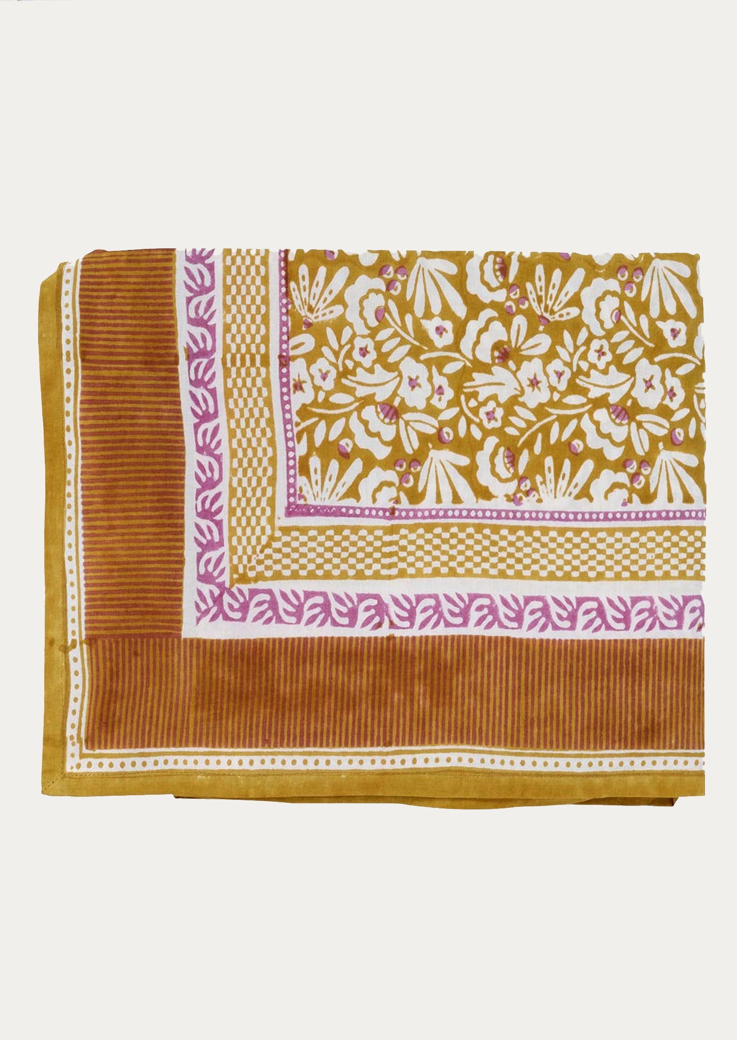 A block printed tablecloth with striped border and floral center in ochre and magenta color palette.