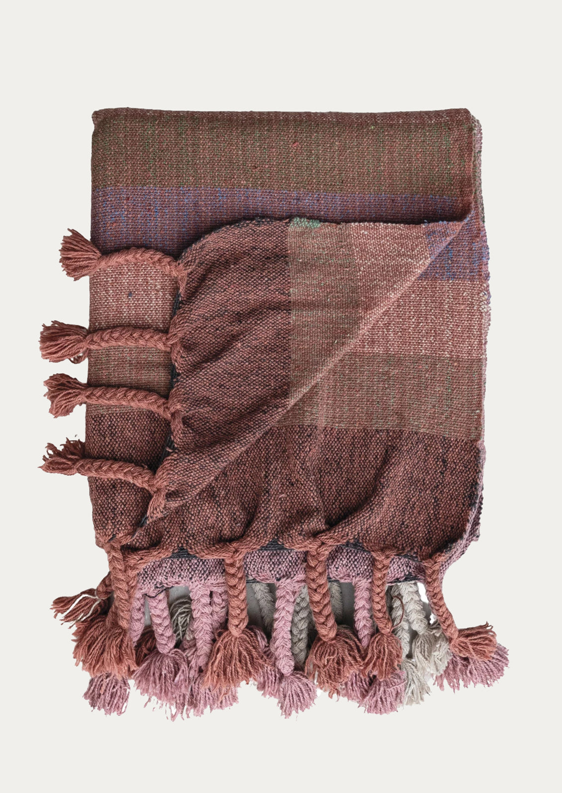 A cotton throw blanket with madras check pattern in shades of pink.
