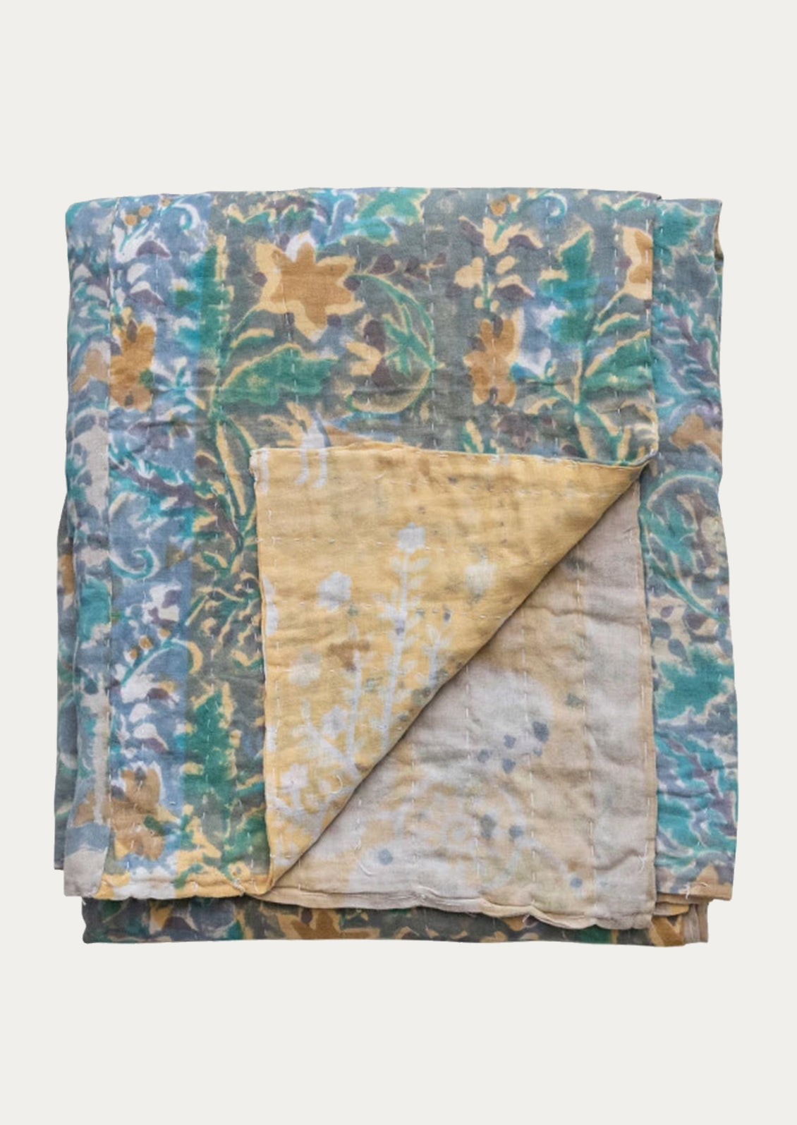 A vintage kantha throw with floral print in grey, yellow, blue and turquoise tones.