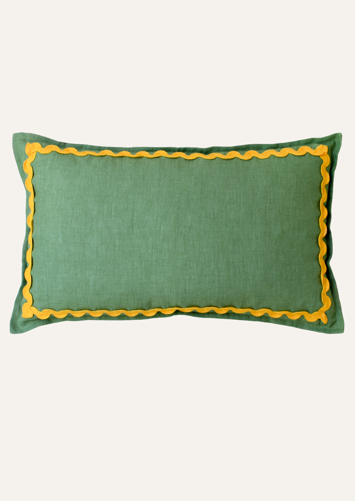A rectangular linen pillow in a kelly green color with a yellow squiggle border attached along the edges.