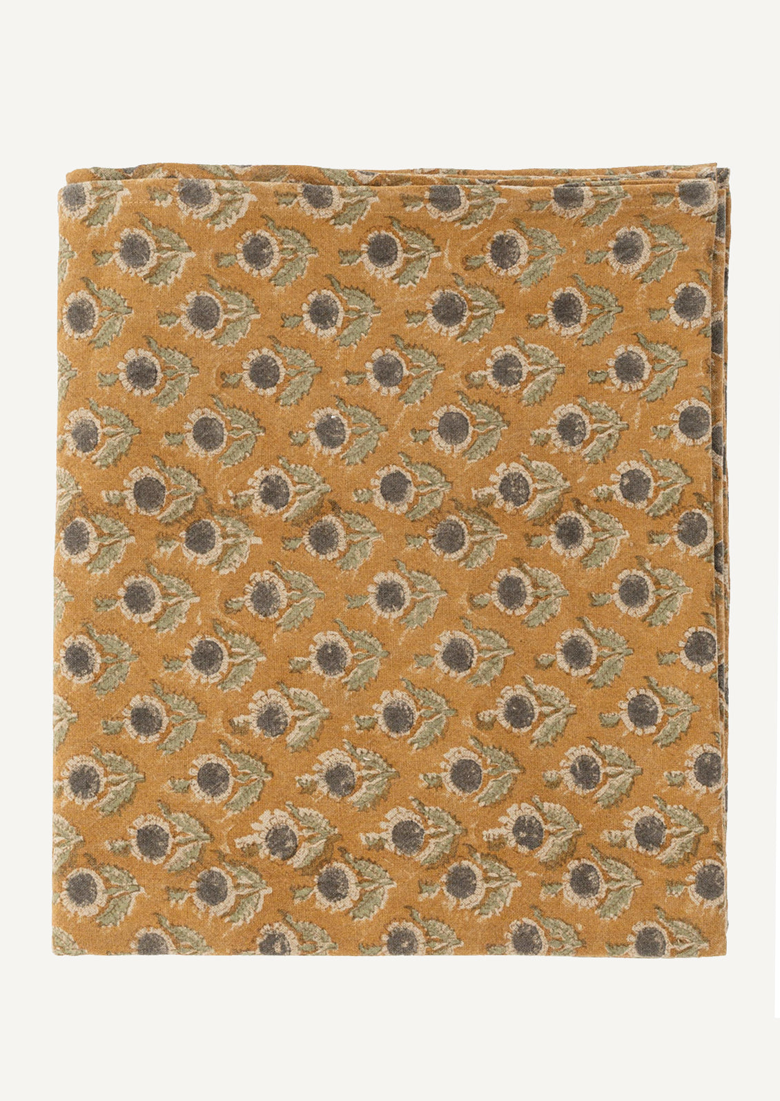 A block print tablecloth in caramel with grey and sage floral pattern.