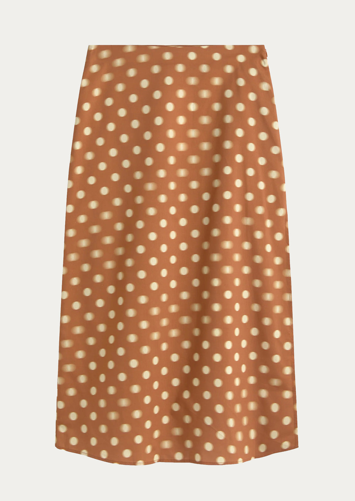Brown skirt with white polka dot pattern on a light gray background