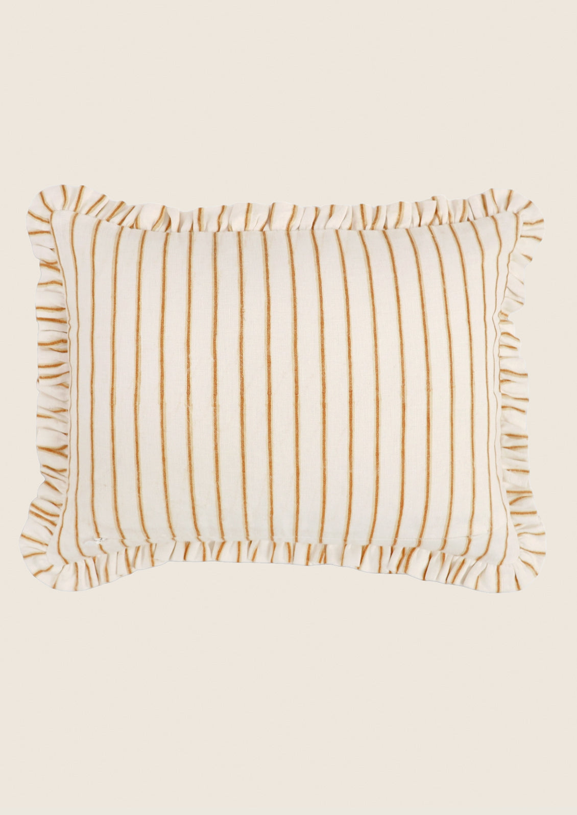 Striped pillow with ruffled edges on a beige background