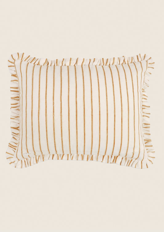 Striped pillow with ruffled edges on a beige background