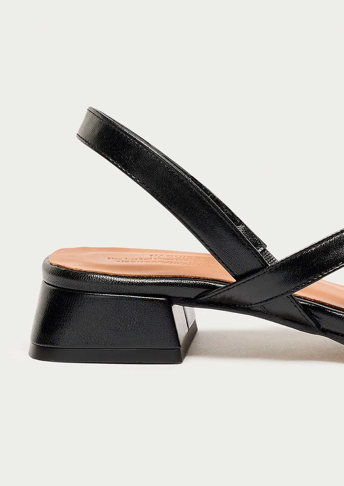 A strappy black leather sandal with a chunky heel.