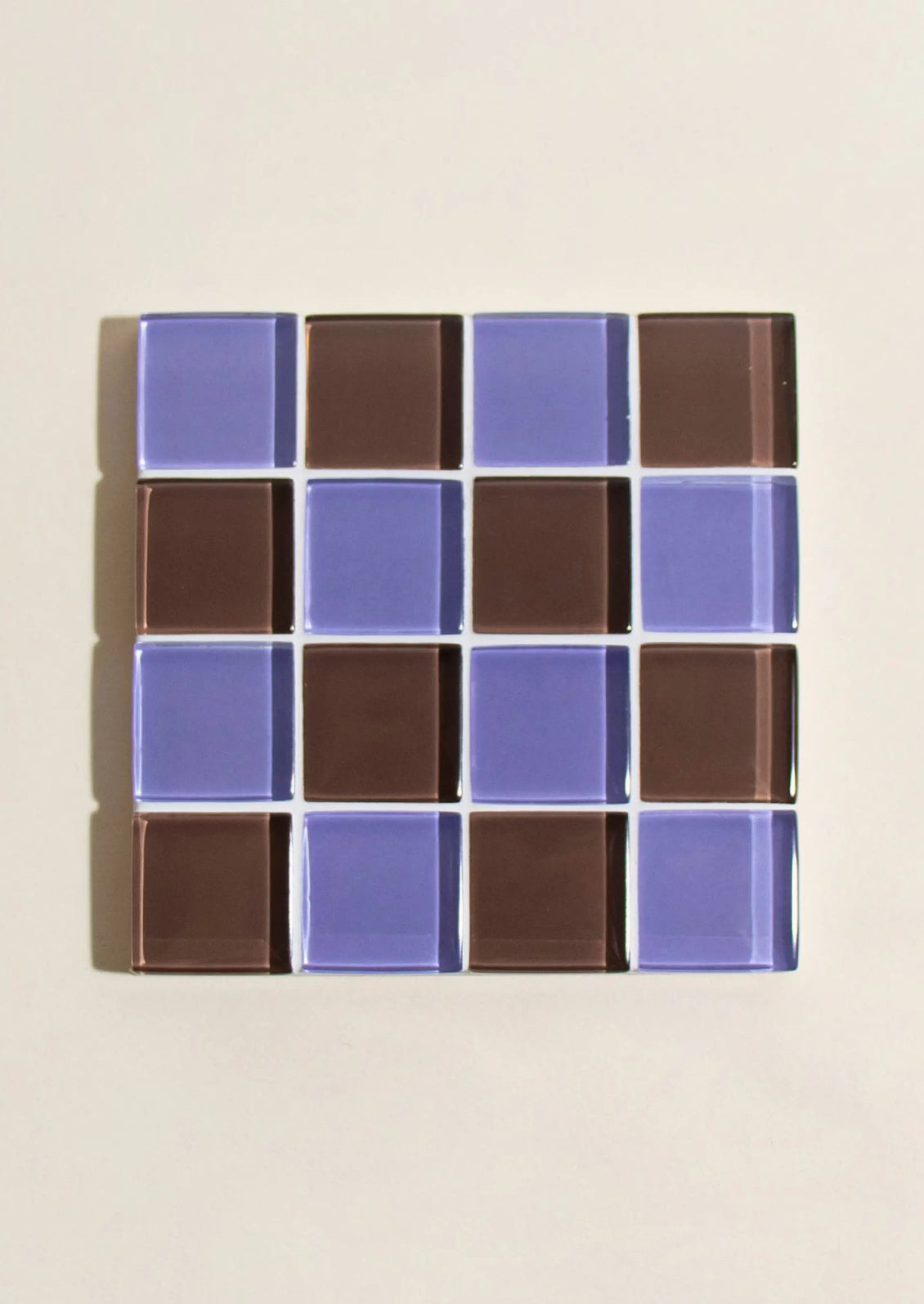 A glass tile coaster in two tone checker pattern.