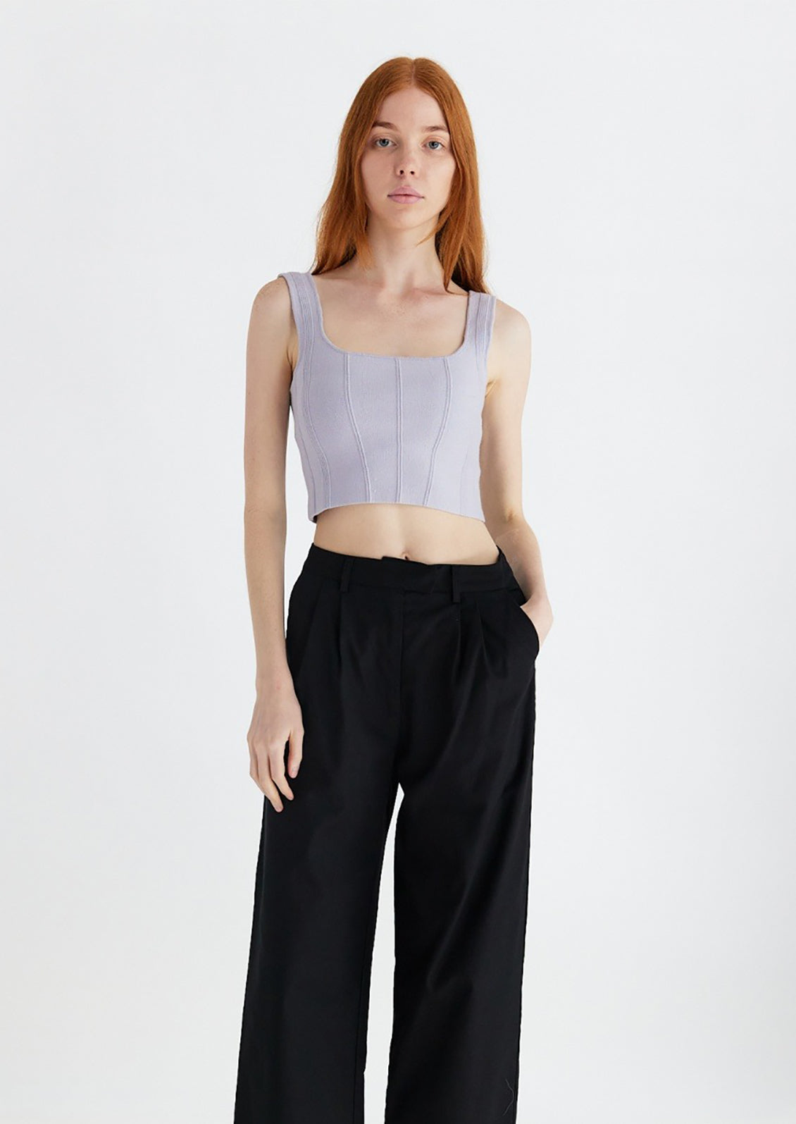 Woman wearing lavender knit cropped tank.