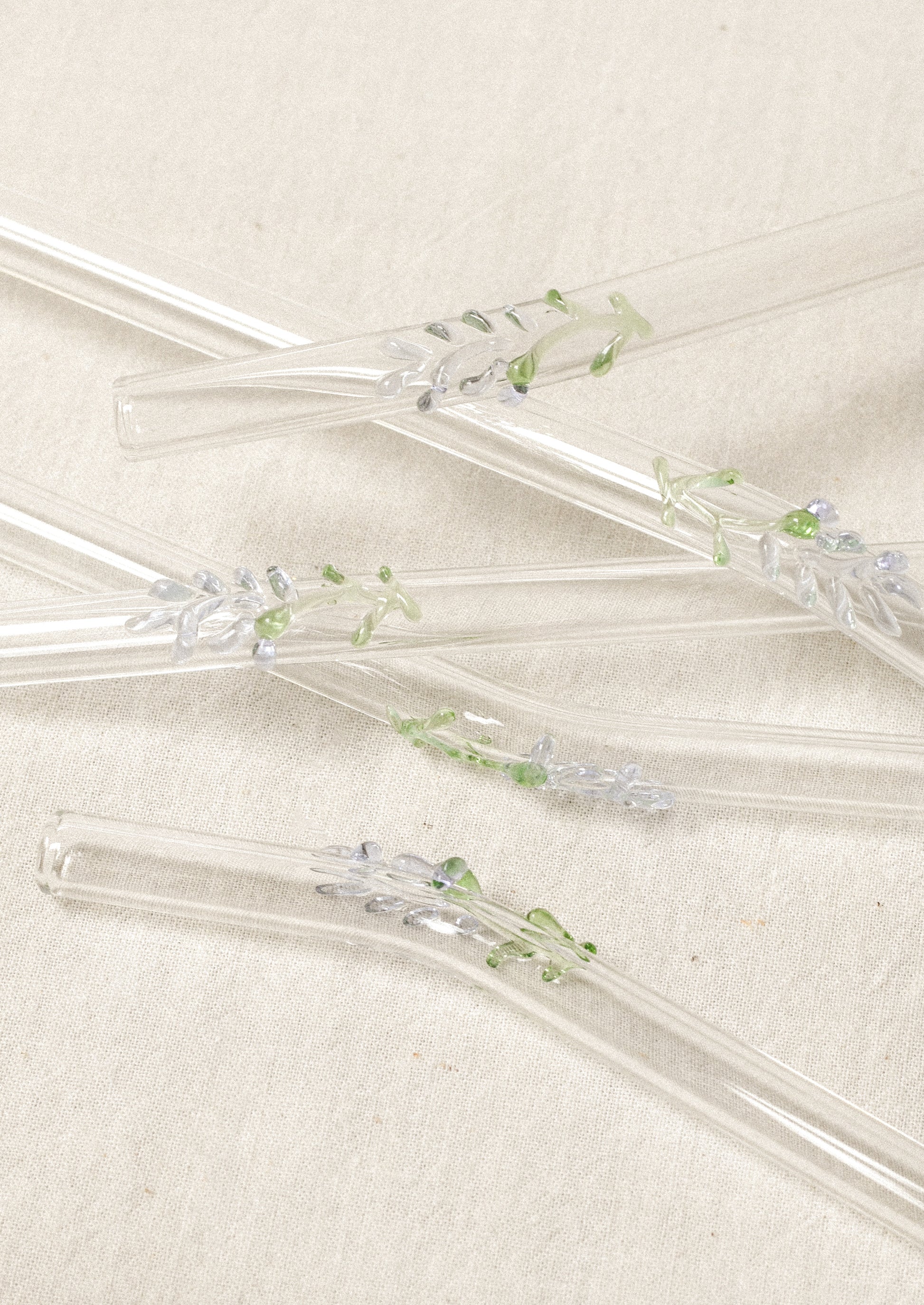 Clear glass straws with bent shape, with lampwork lavender figurine.