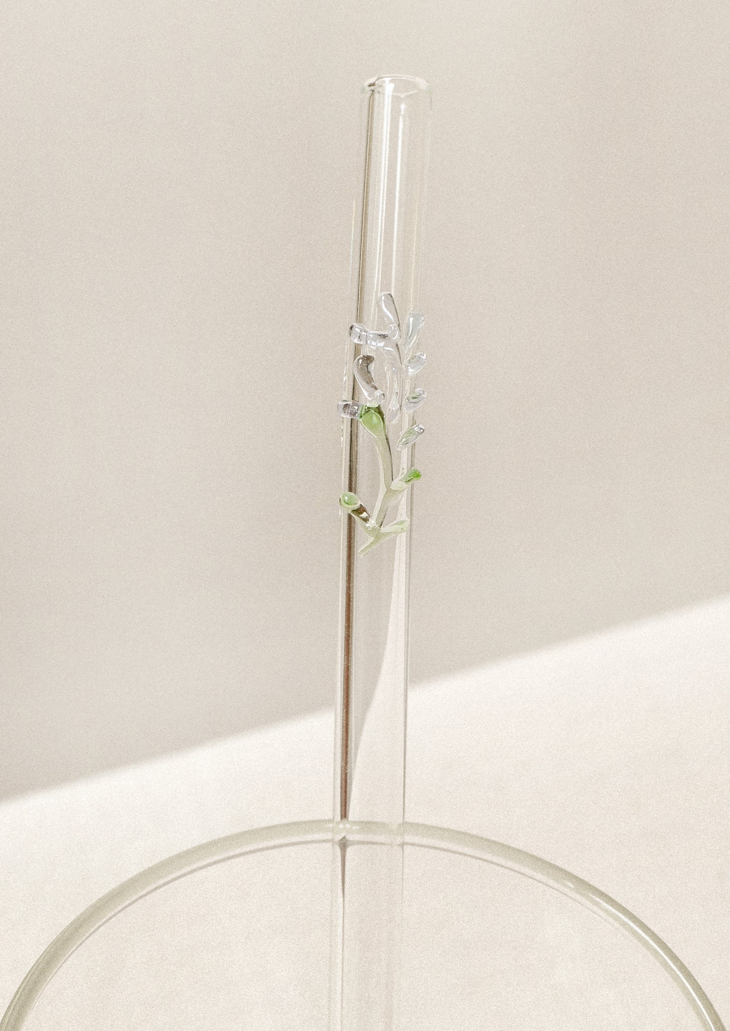 Clear glass straw with bent shape, with lampwork lavender figurine.
