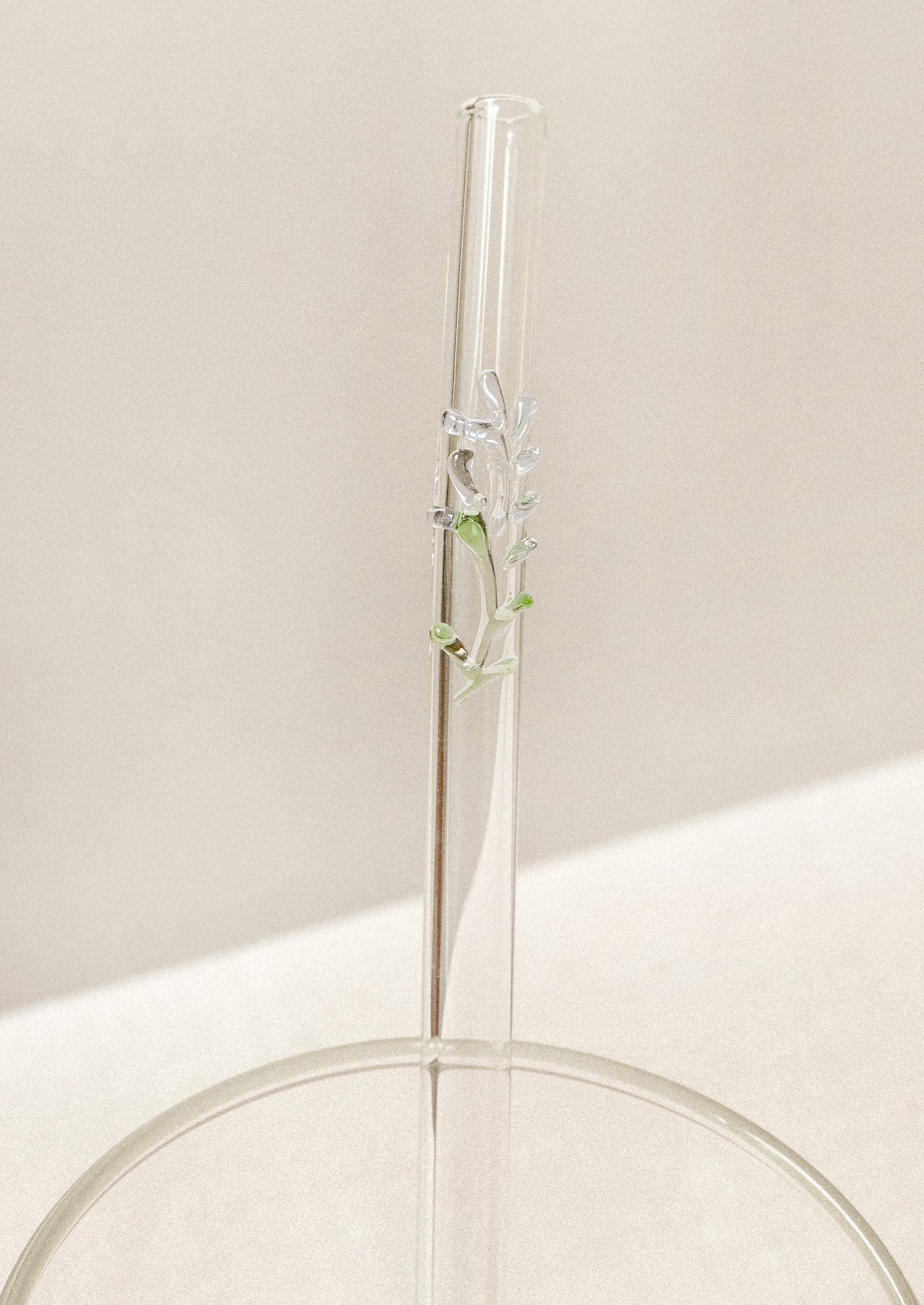 Clear glass straw with bent shape, with lampwork lavender figurine.