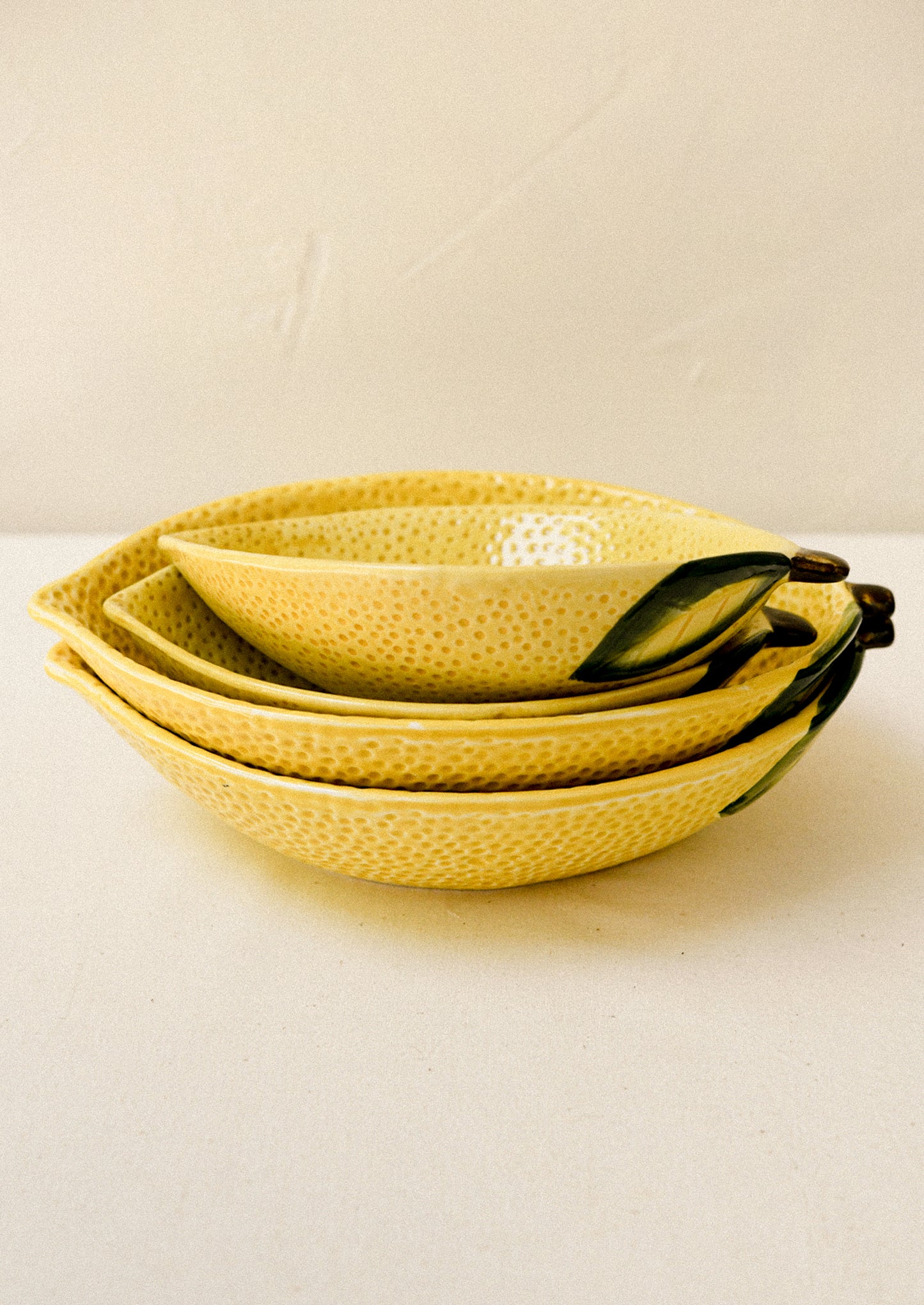 Ceramic serving bowls in the shape of a lemon.