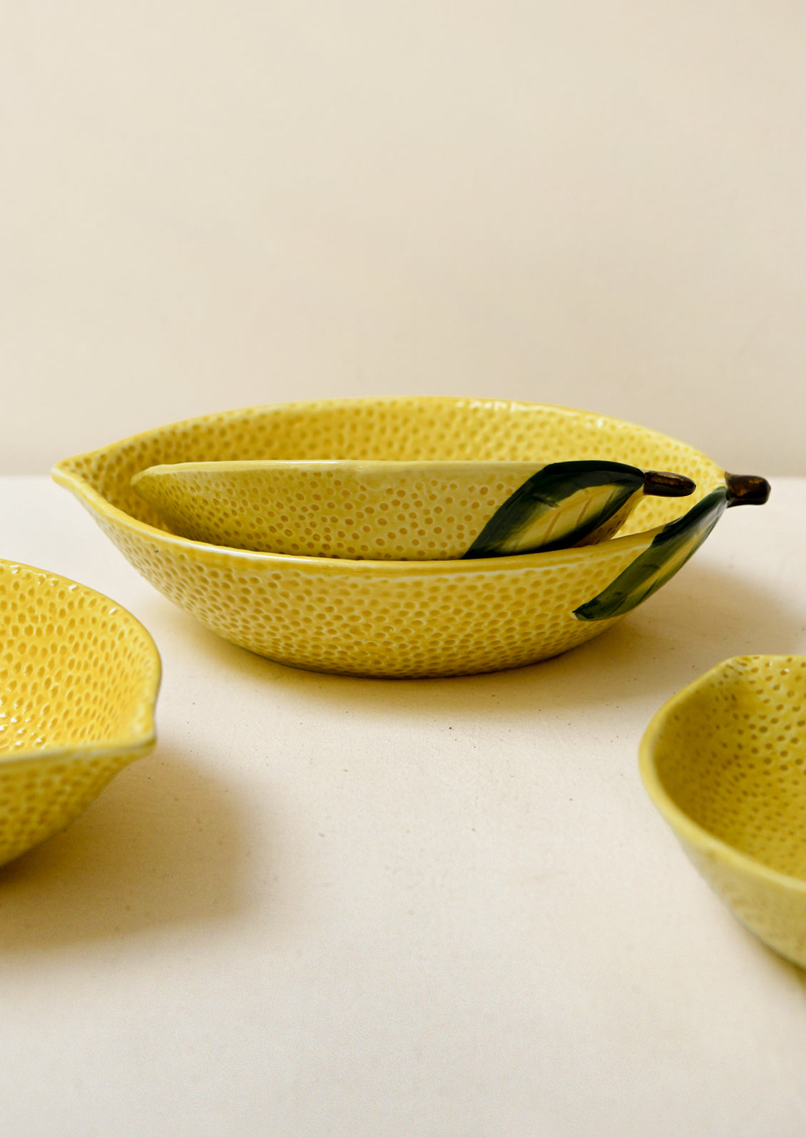 Ceramic serving bowls in the shape of a lemon.