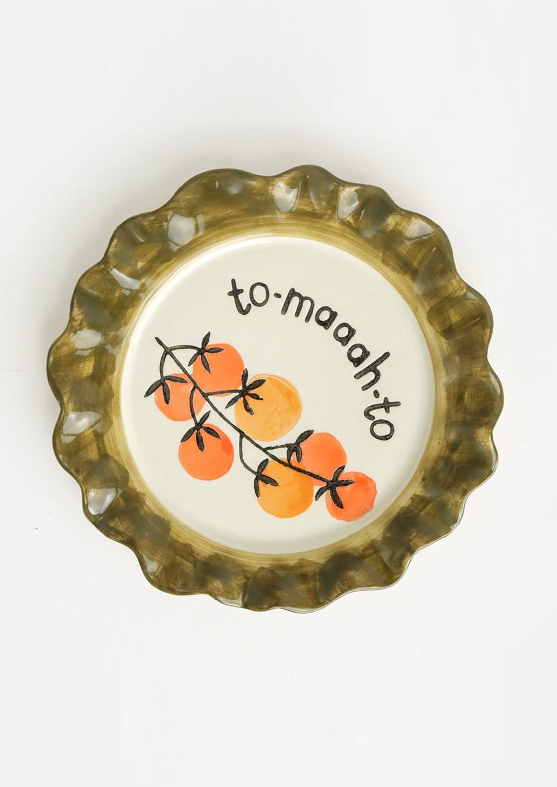 A printed ceramic plate with olive rim and tomato print at center.