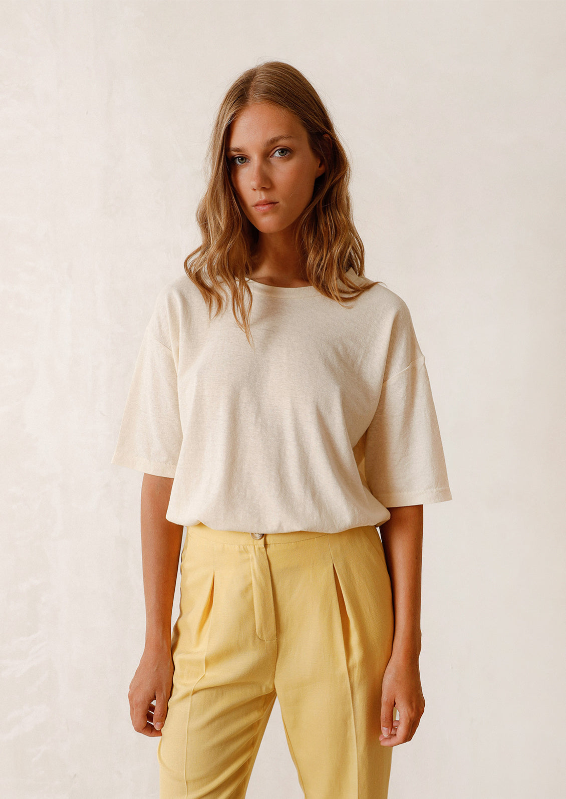 Woman wearing ecru tee. 