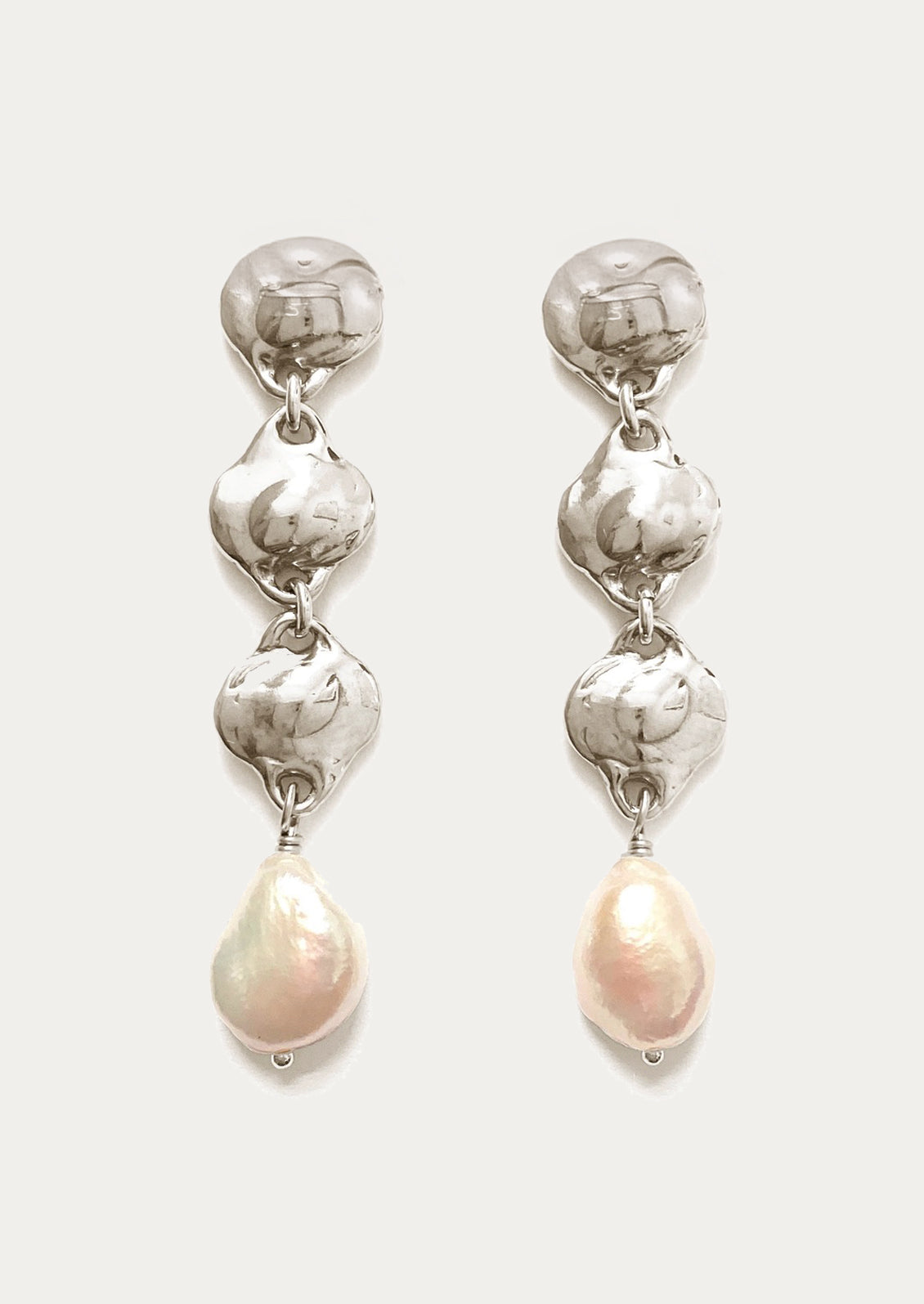 A pair of sterling silver earrings with triple pendant style and pearl charm.