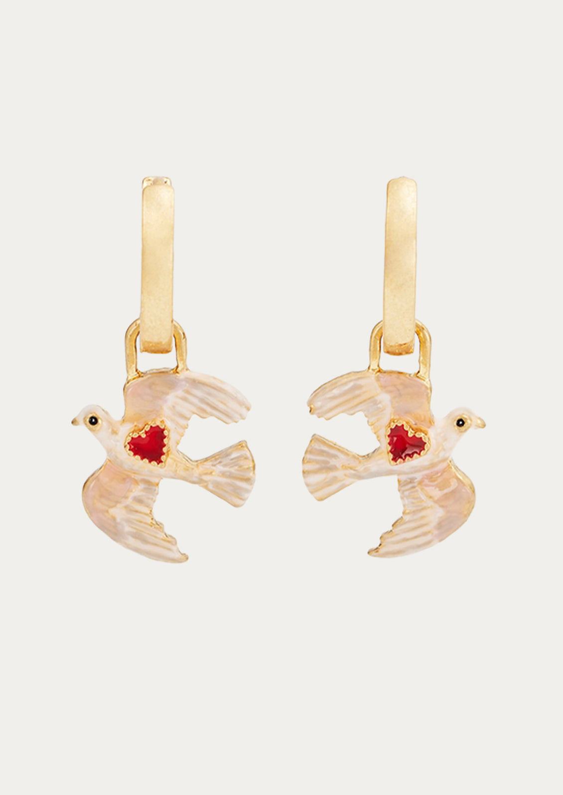 A pair of gold hoop earrings with dove charms adorned with a red heart.