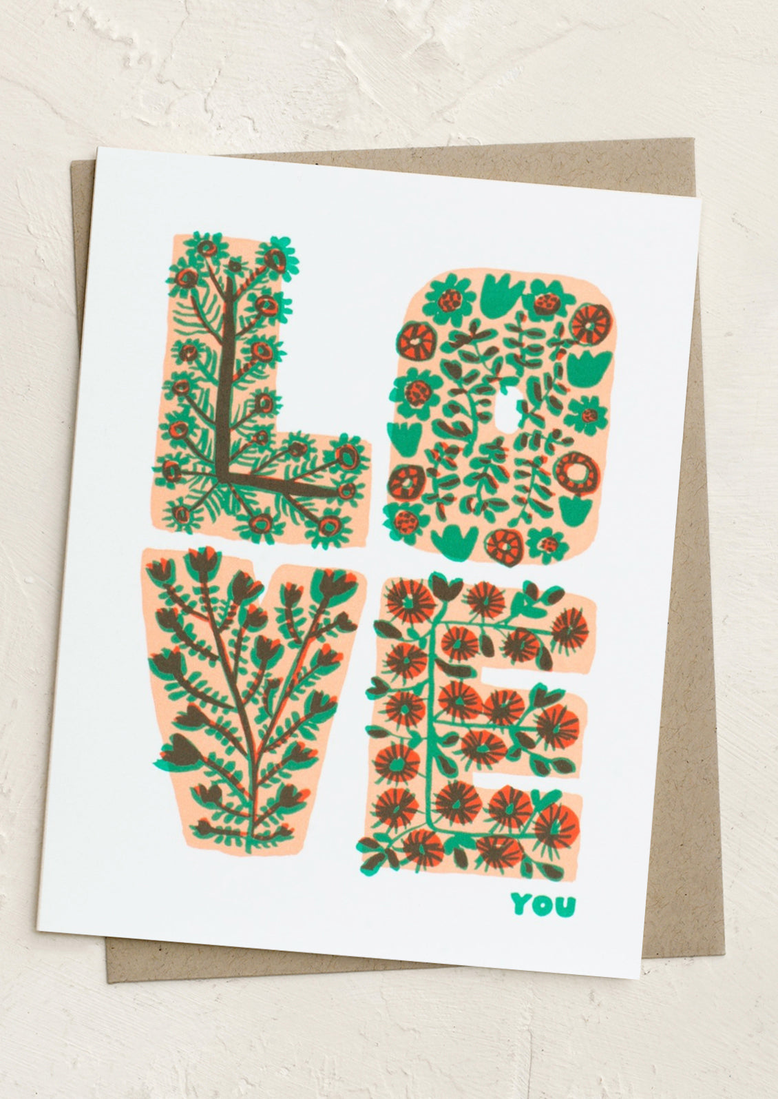 A card with flowering lettering reading "LOVE you".
