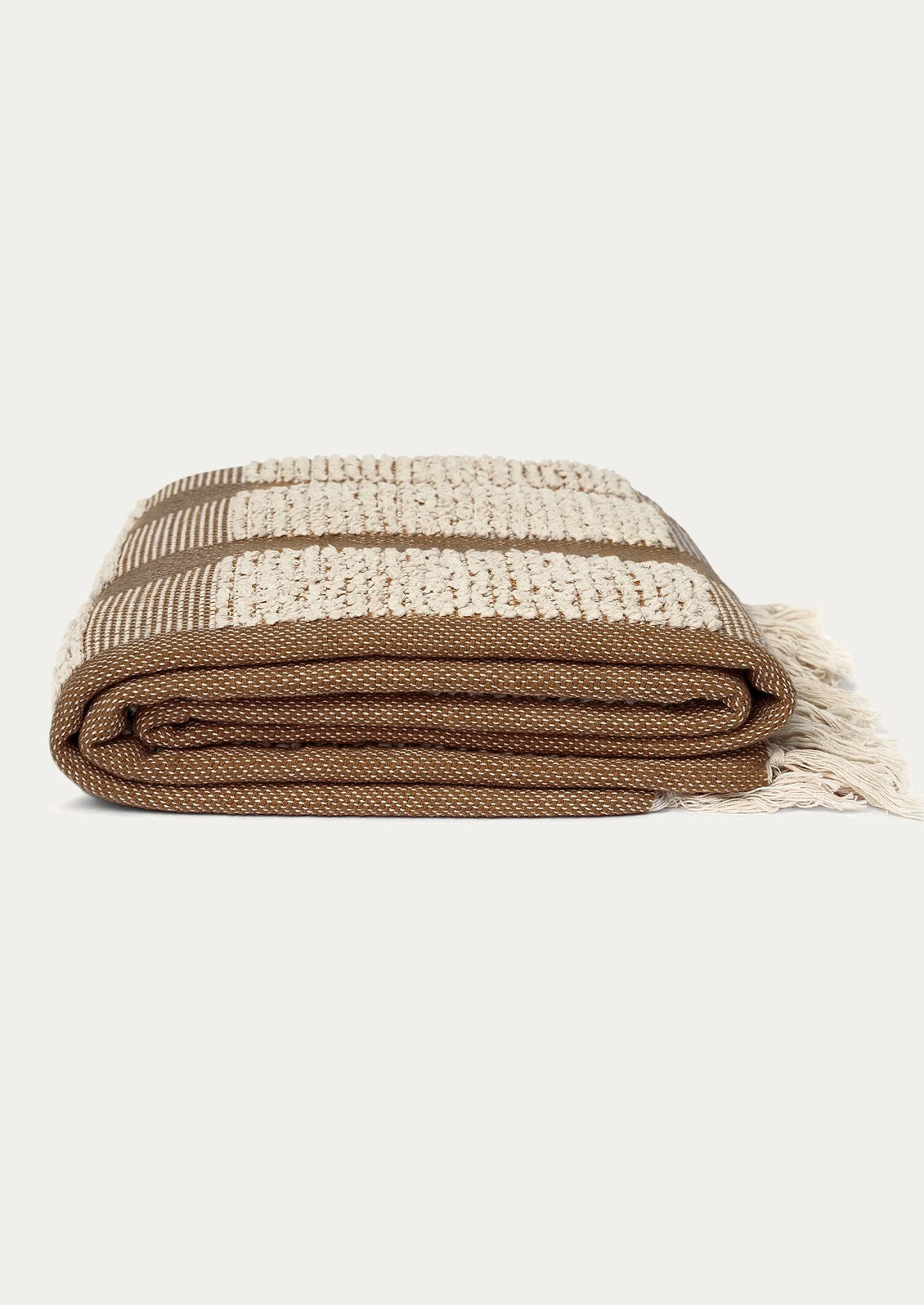 Folded woven blanket with brown and beige pattern on a white background