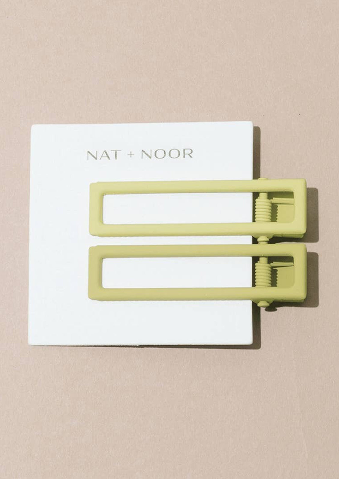 A pair of bar-shaped hair clips in lemon and citron.