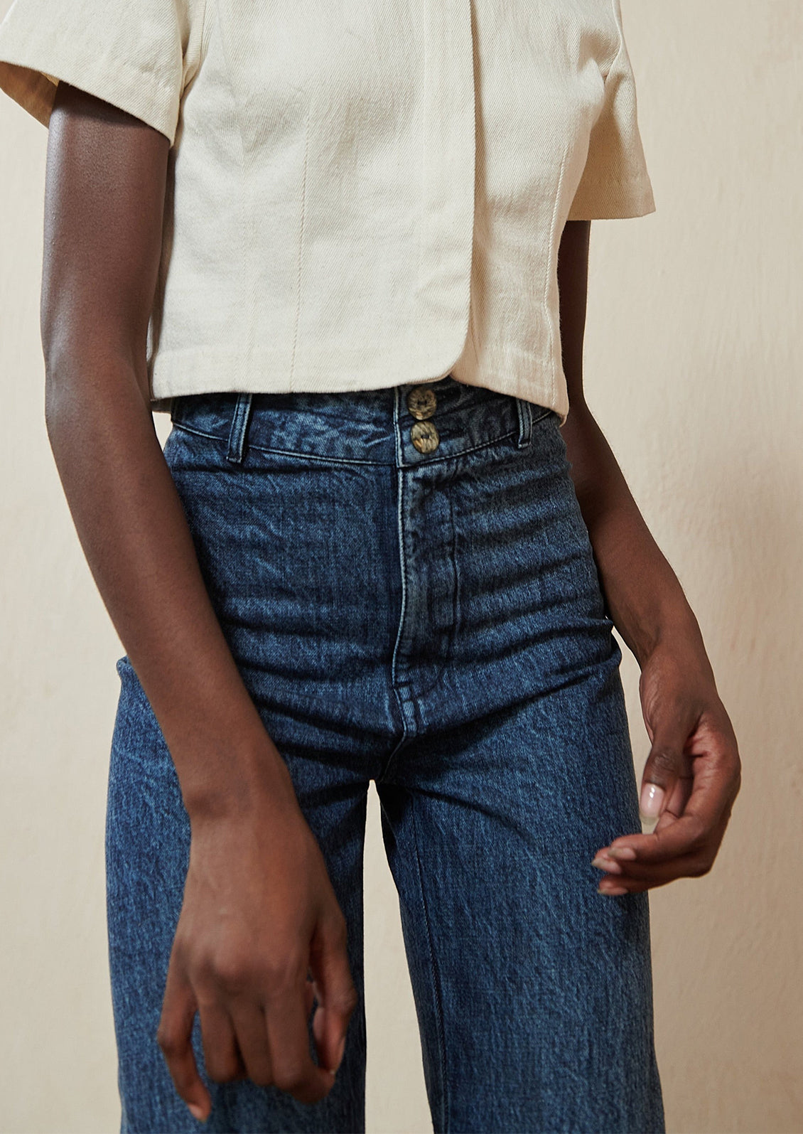 Woman wearing blue jeans and white tops. 