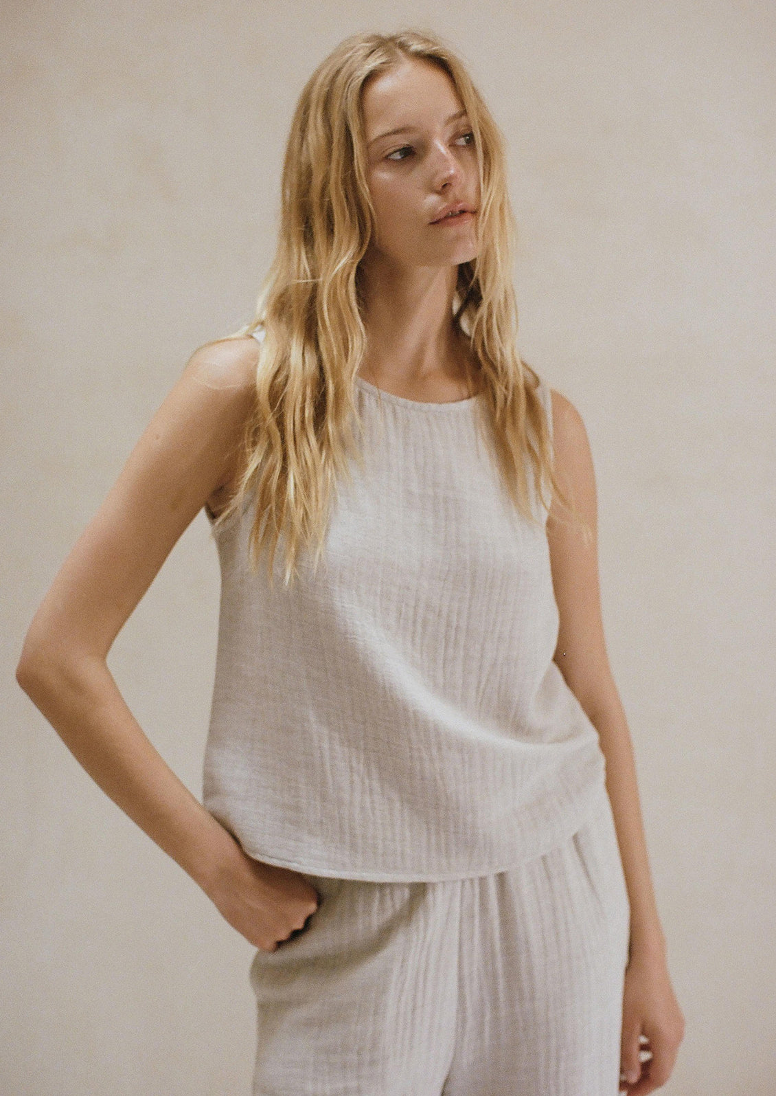 Woman wearing grey linen tank. 
