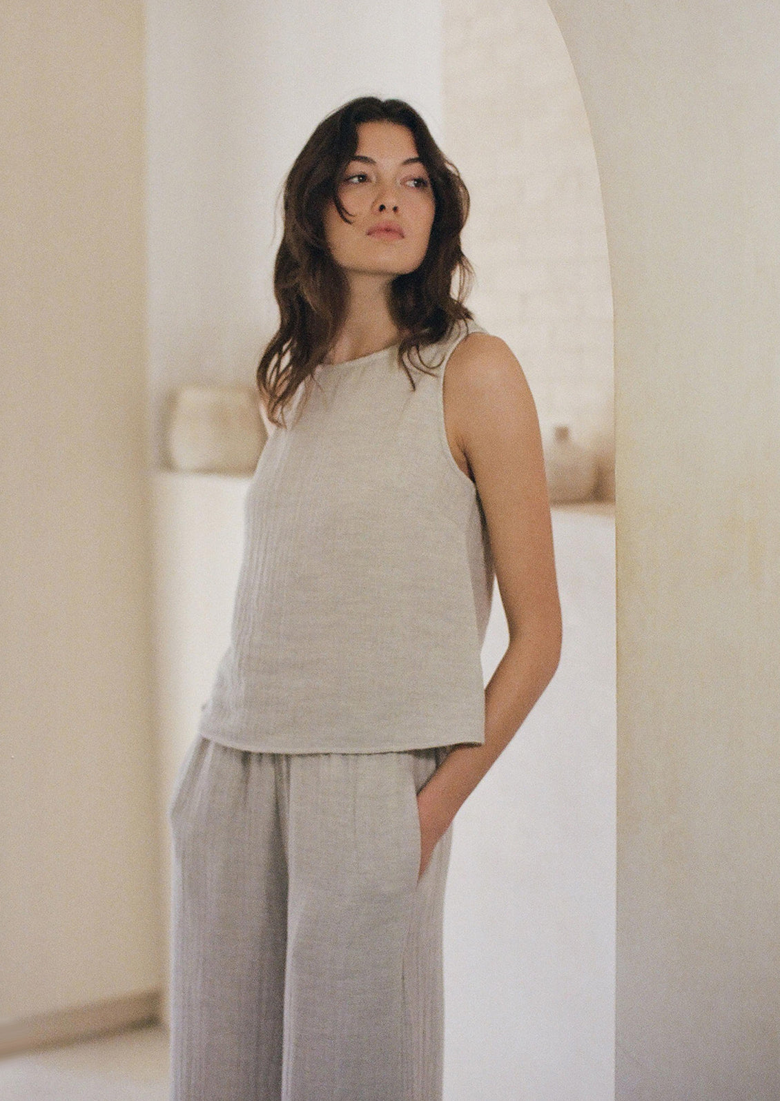 Woman wearing grey linen tank. 