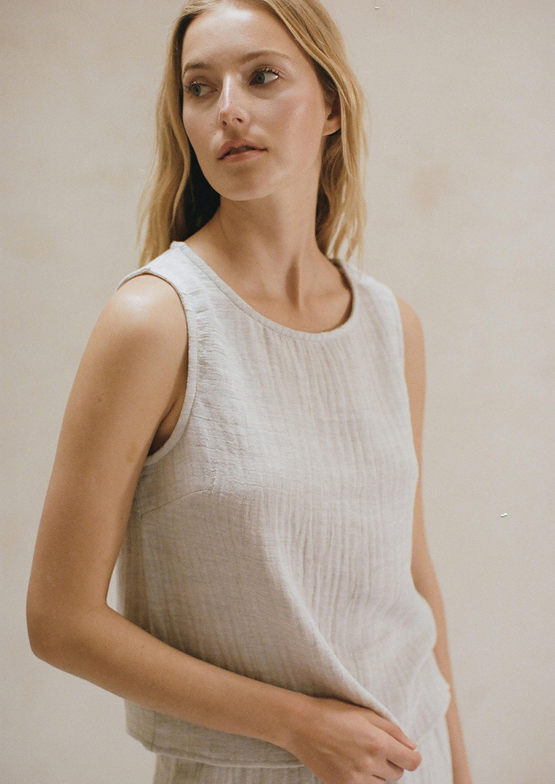 Woman wearing grey linen tank. 