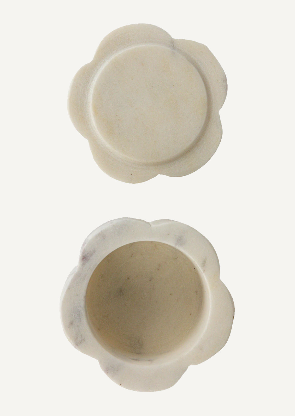 A stacked set of two flower-shaped marble pinch pots with lid on top.