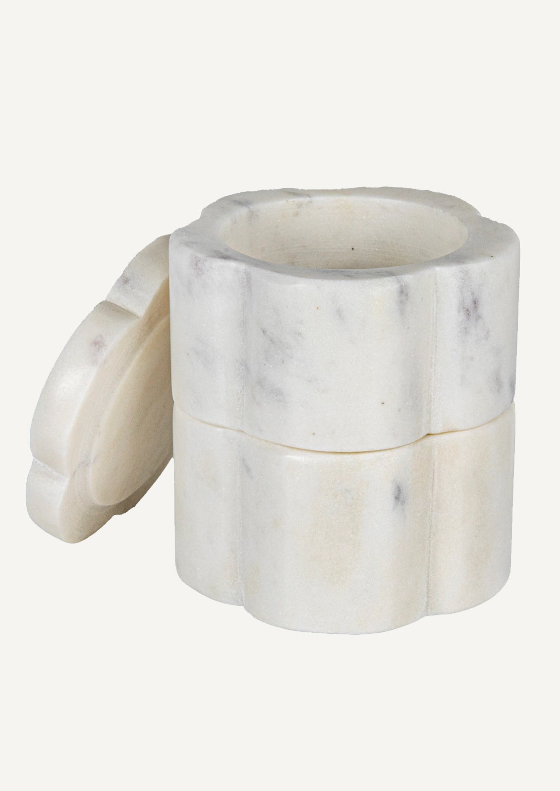 A stacked set of two flower-shaped marble pinch pots with lid on top.