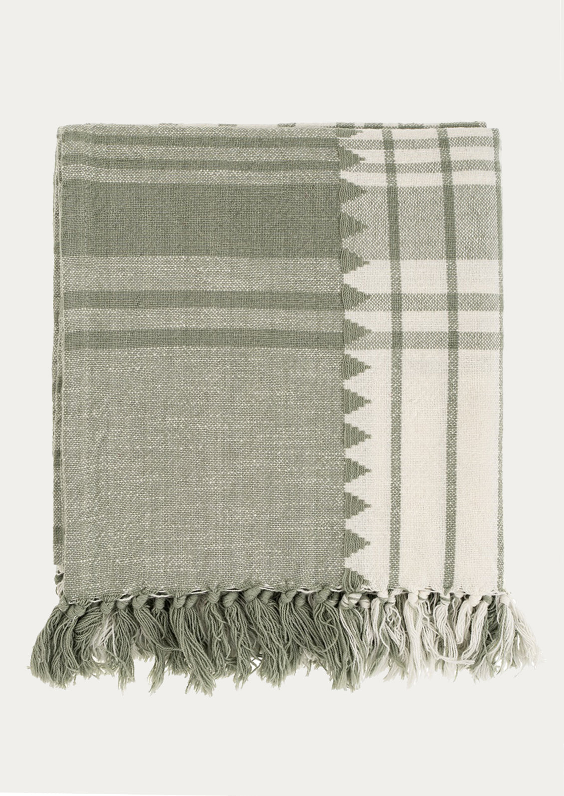 A cotton throw in cream and sage green with woven plaid pattern and embroidered triangles.
