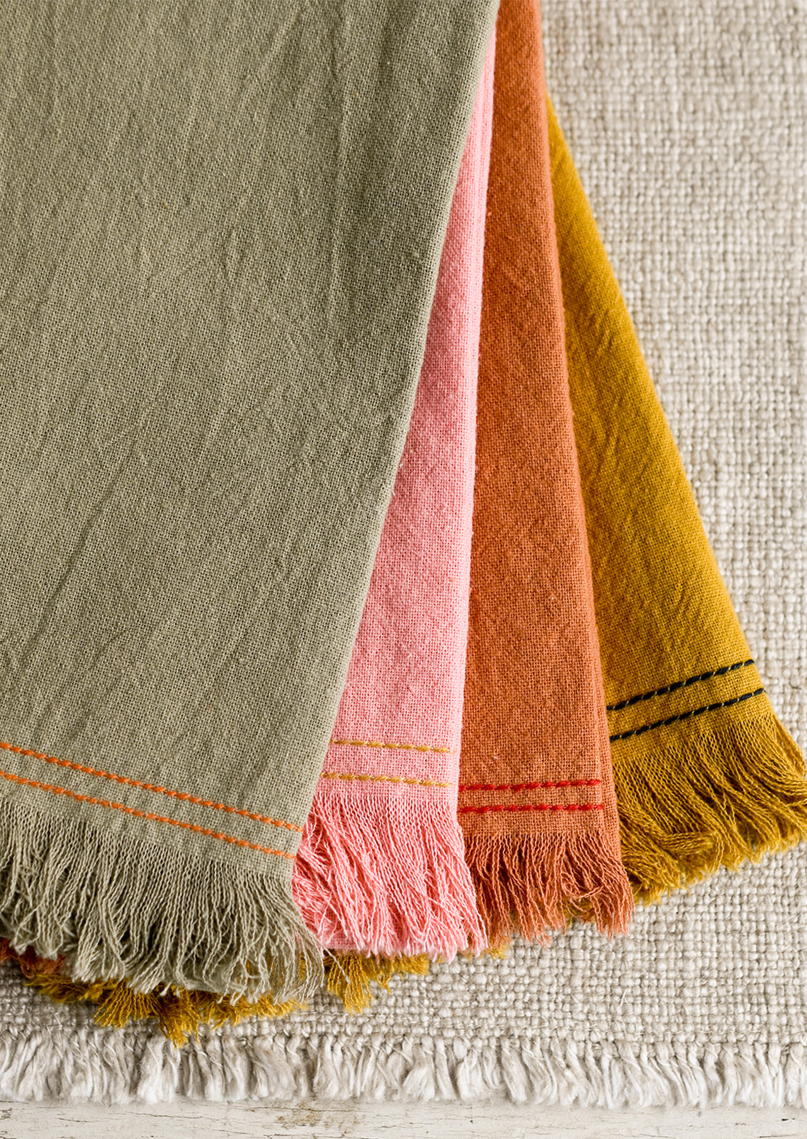 Assorted colors of cotton tea towel with contrast stitchings.