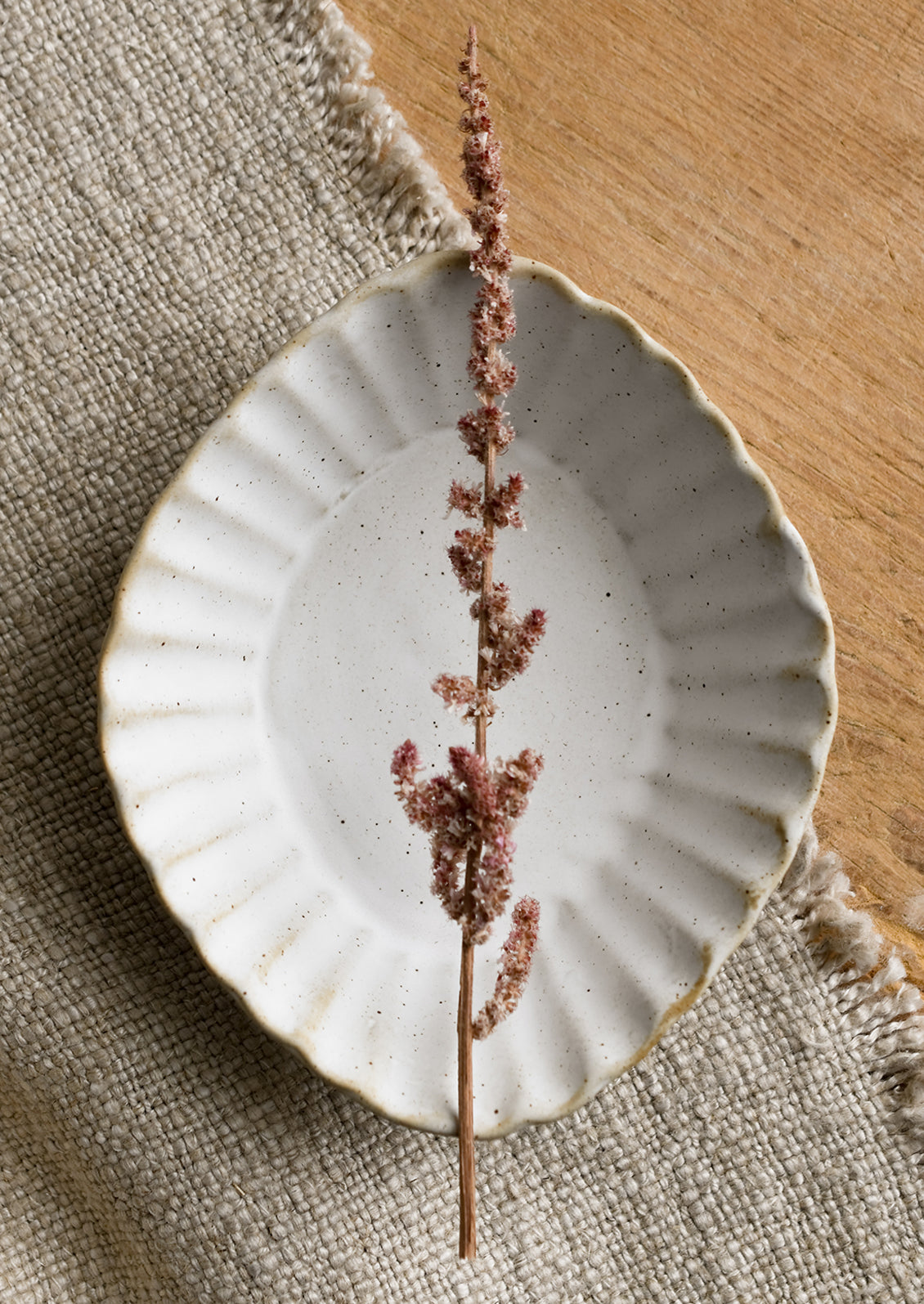 A pleated stoneware dish in diamond shape.