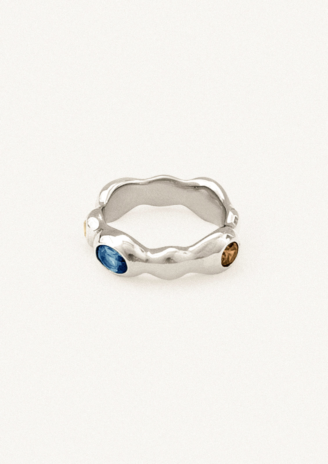 A unique sterling silver ring with various colored gems.