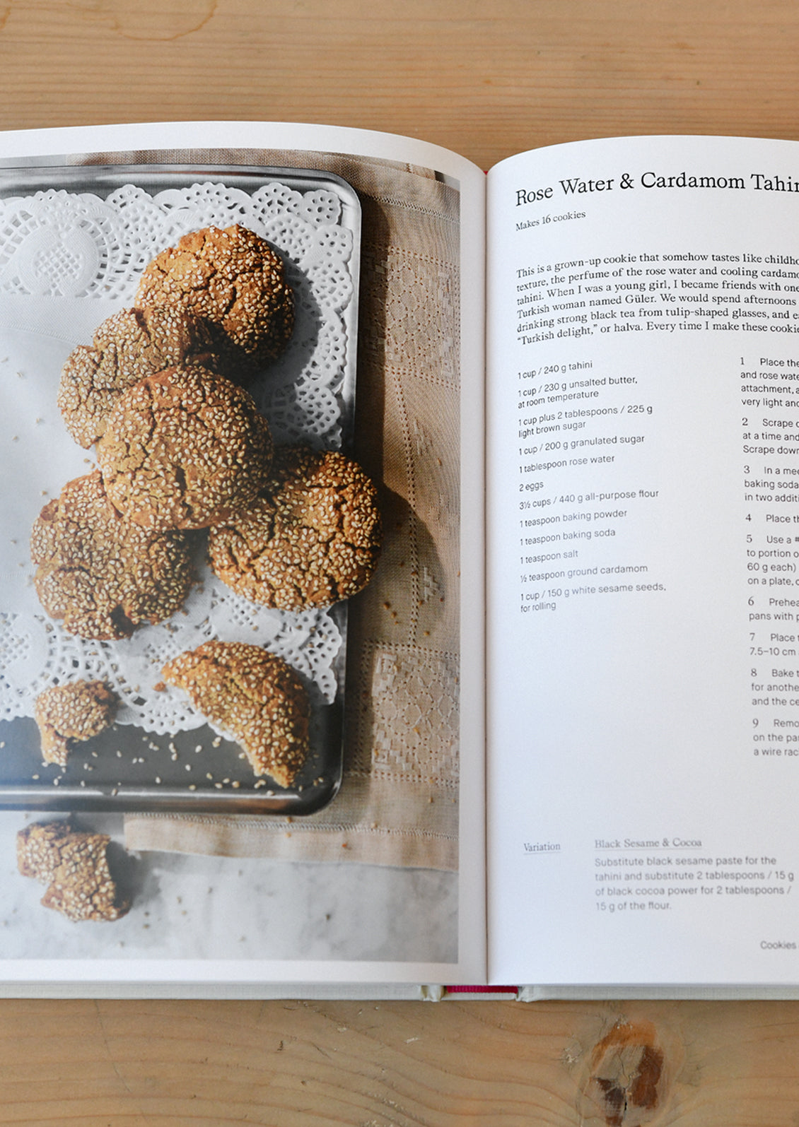 An open cookbook showing a recipe for rose water & cardamom tahini cookies.