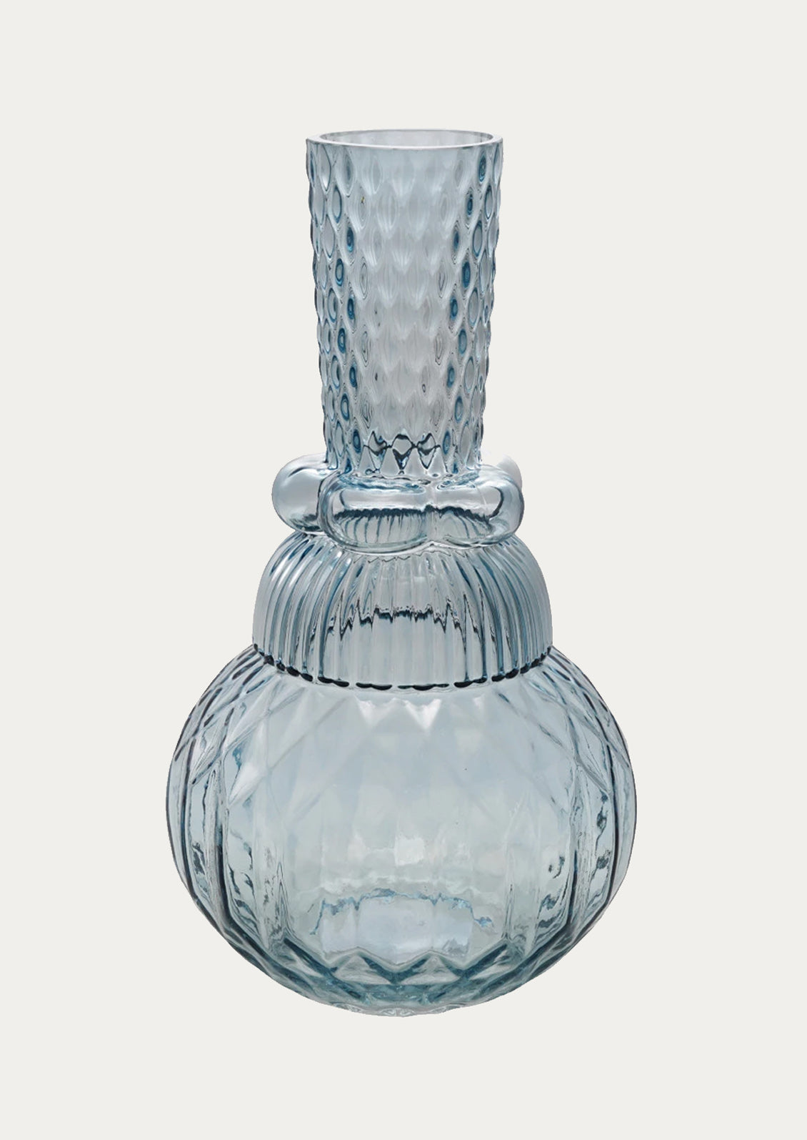 A glass vase in different textures in light blue color.