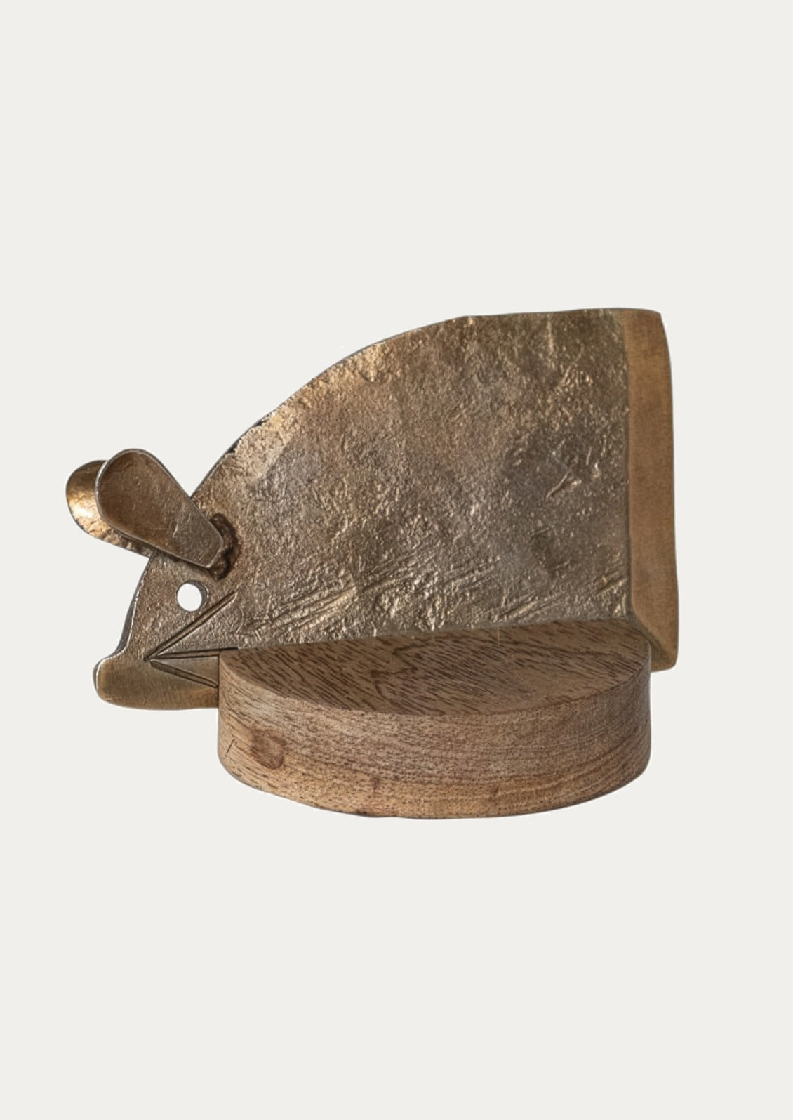 Decorative metal object with a textured surface on a light gray background