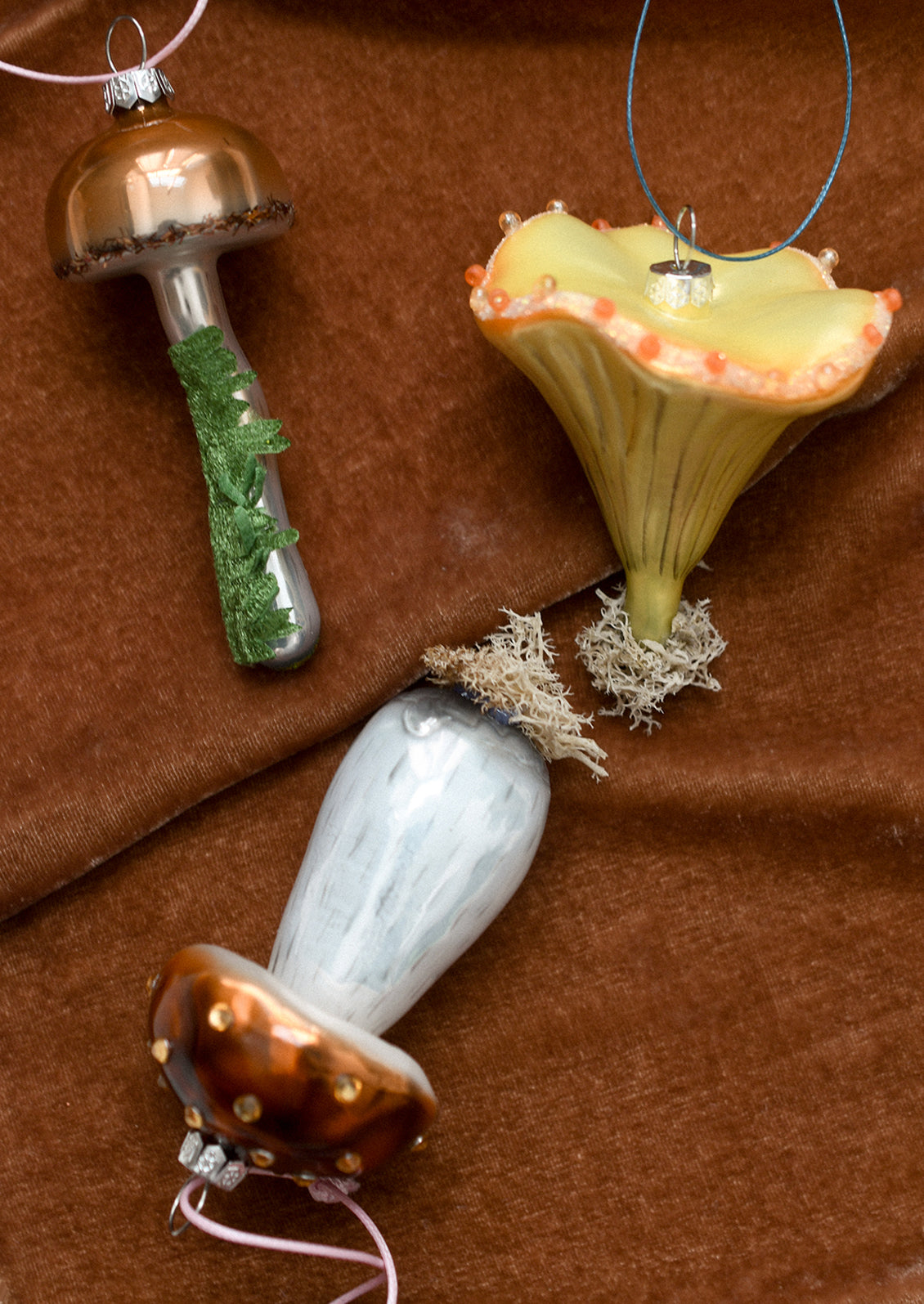 Glass ornaments resembling different types of forest mushrooms.