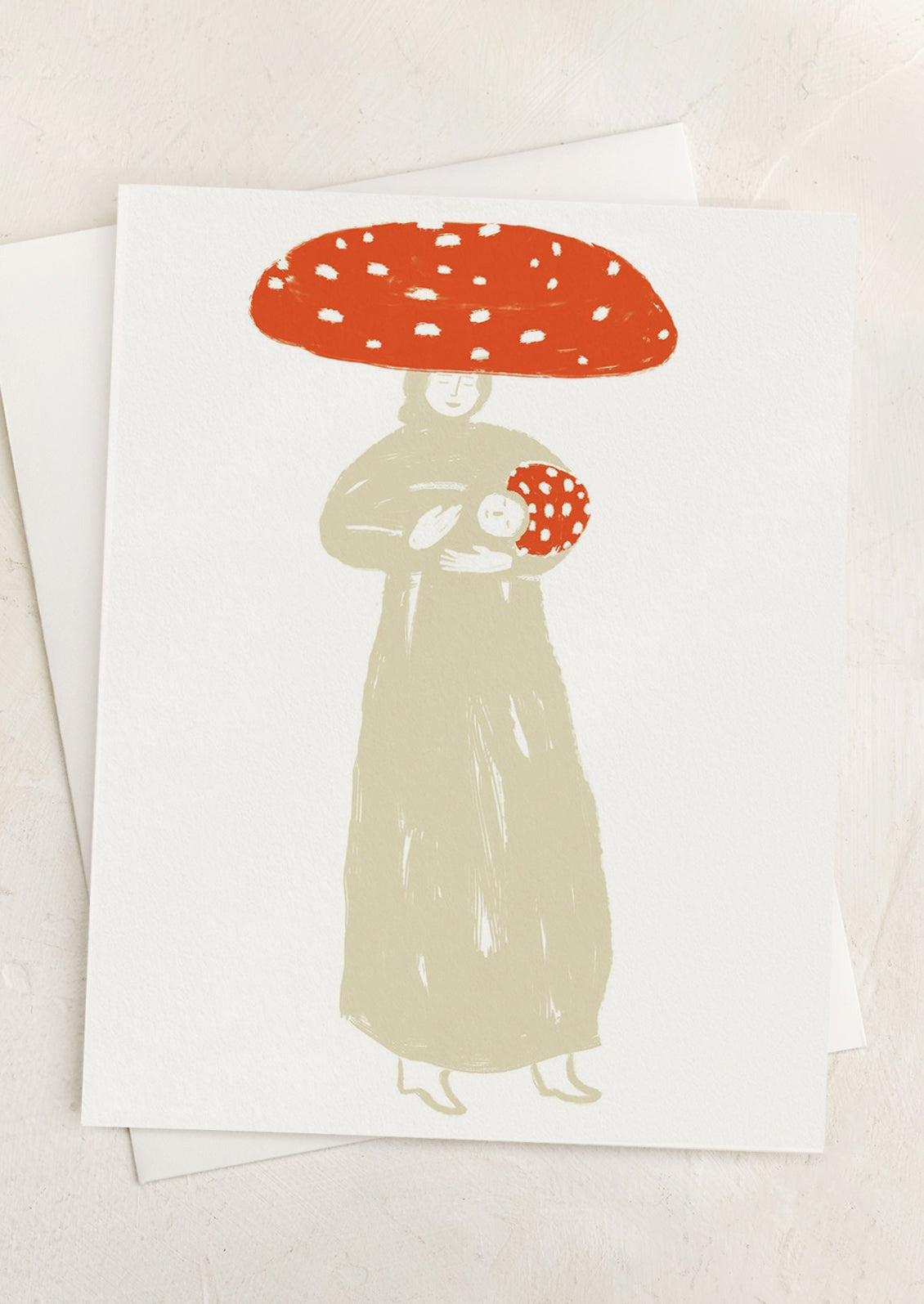 A greeting card with illustration of woman wearing big mushroom cap, holding baby wearing matching mushroom cap.